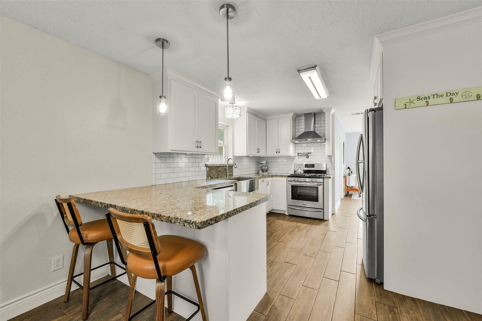 19611 Suncove Lane, Humble, TX 77346 Pull up a stool for morning coffee or keep the cook company at the breakfast bar. Pendant lighting, white cabinetry and warm-toned countertops create a kitchen that balances inviting style with everyday function