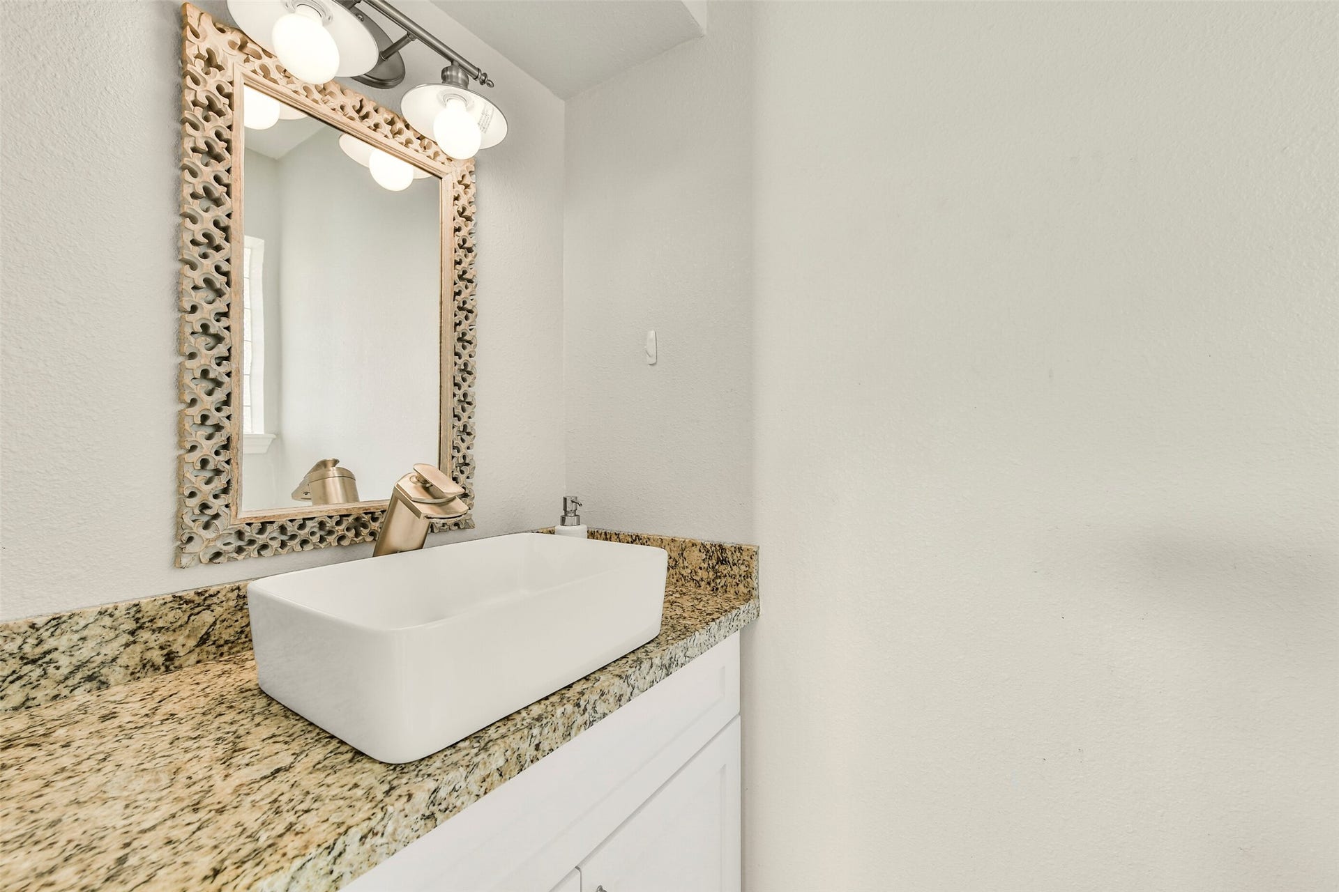 19611 Suncove Lane, Humble, TX 77346 A small space with a stylish finish. A rectangular vessel sink, patterned countertop and decorative framed mirror bring personality to the vanity, creating a polished detail guests will appreciate.