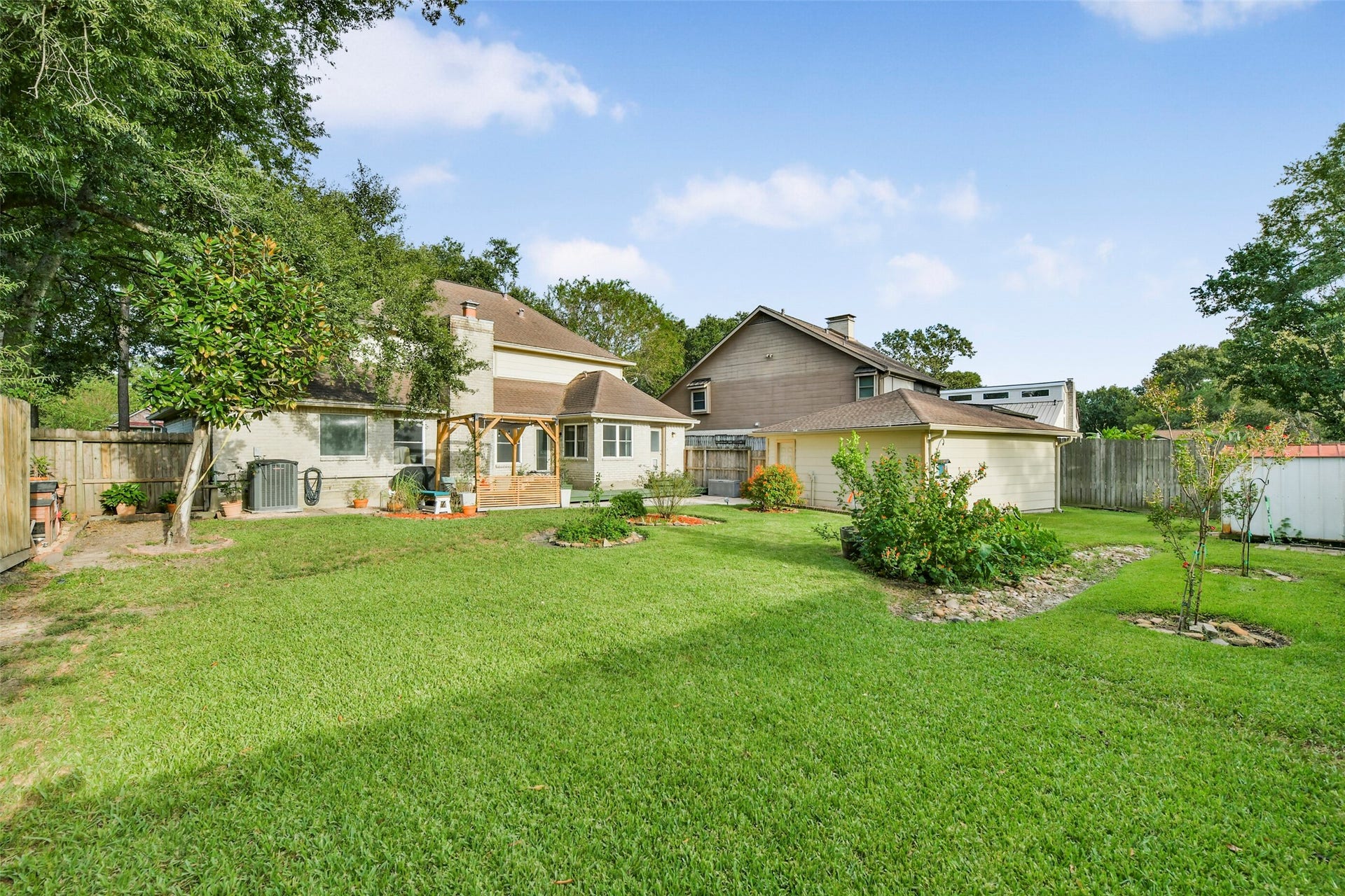 19611 Suncove Lane, Humble, TX 77346 Take everyday living outdoors. This expansive, fenced backyard offers room for lawn games, gardening and weekend gatherings, with established trees and planted beds giving the open space a welcoming sense of character.
