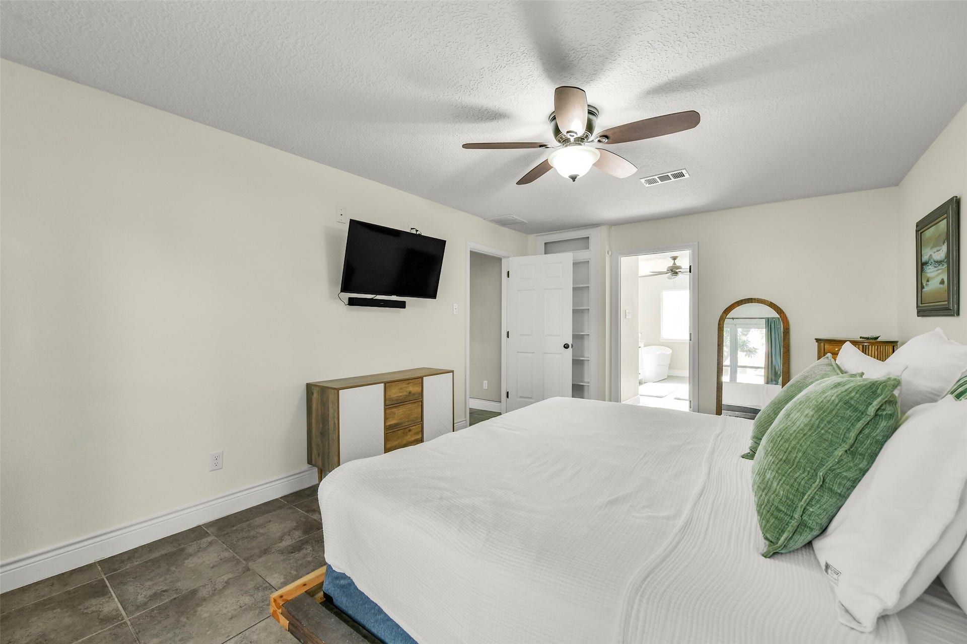 19611 Suncove Lane, Humble, TX 77346 A comfortable retreat with room to truly settle in. The bedrooms spacious layout accommodates additional furnishings, while direct access to the adjoining bath adds everyday convenience.