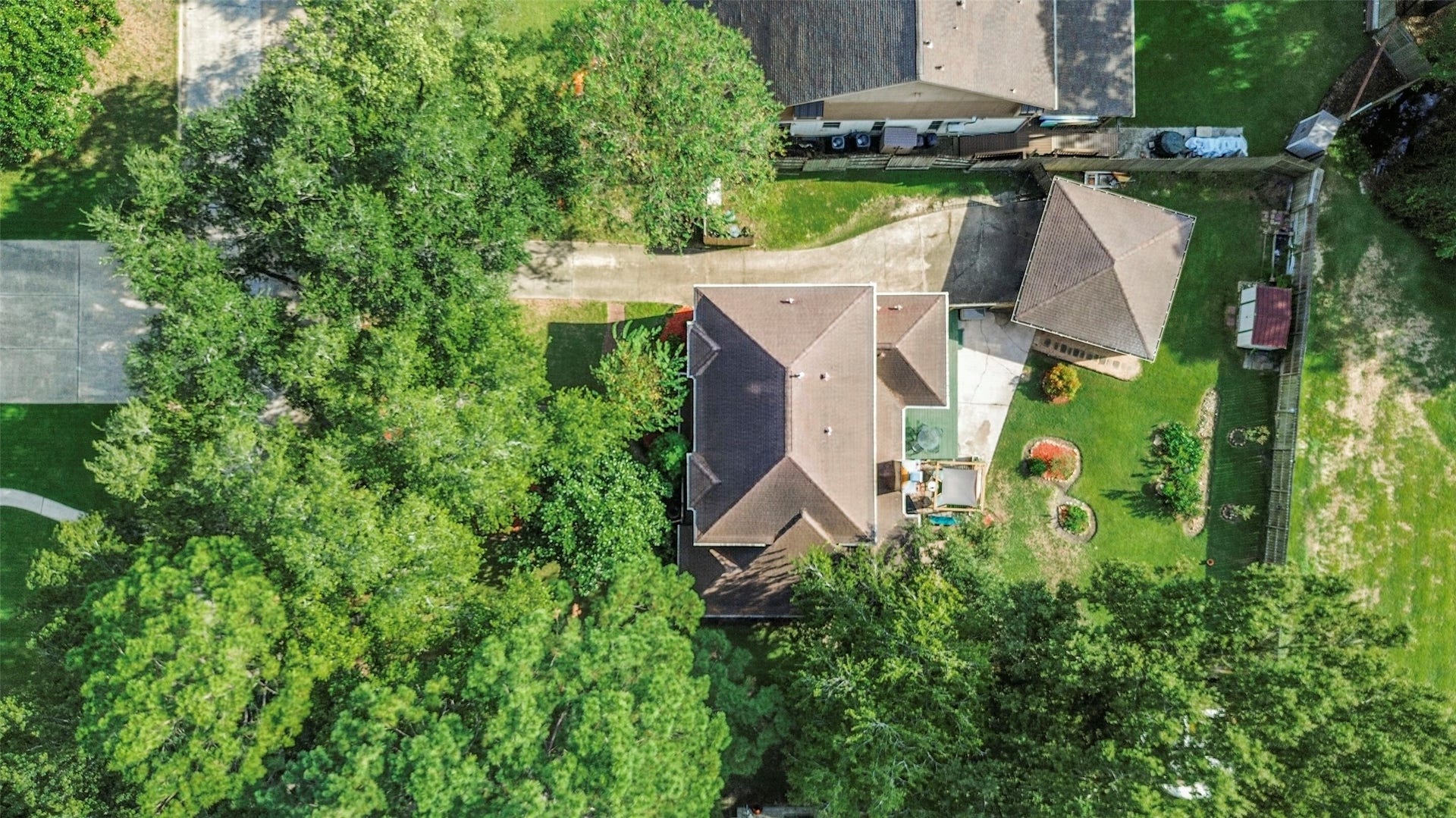 19611 Suncove Lane, Humble, TX 77346 Room to enjoy life outdoors! This overhead perspective showcases the homes spacious yard, extended driveway and separate garage, with mature trees adding shade and a beautiful natural backdrop.