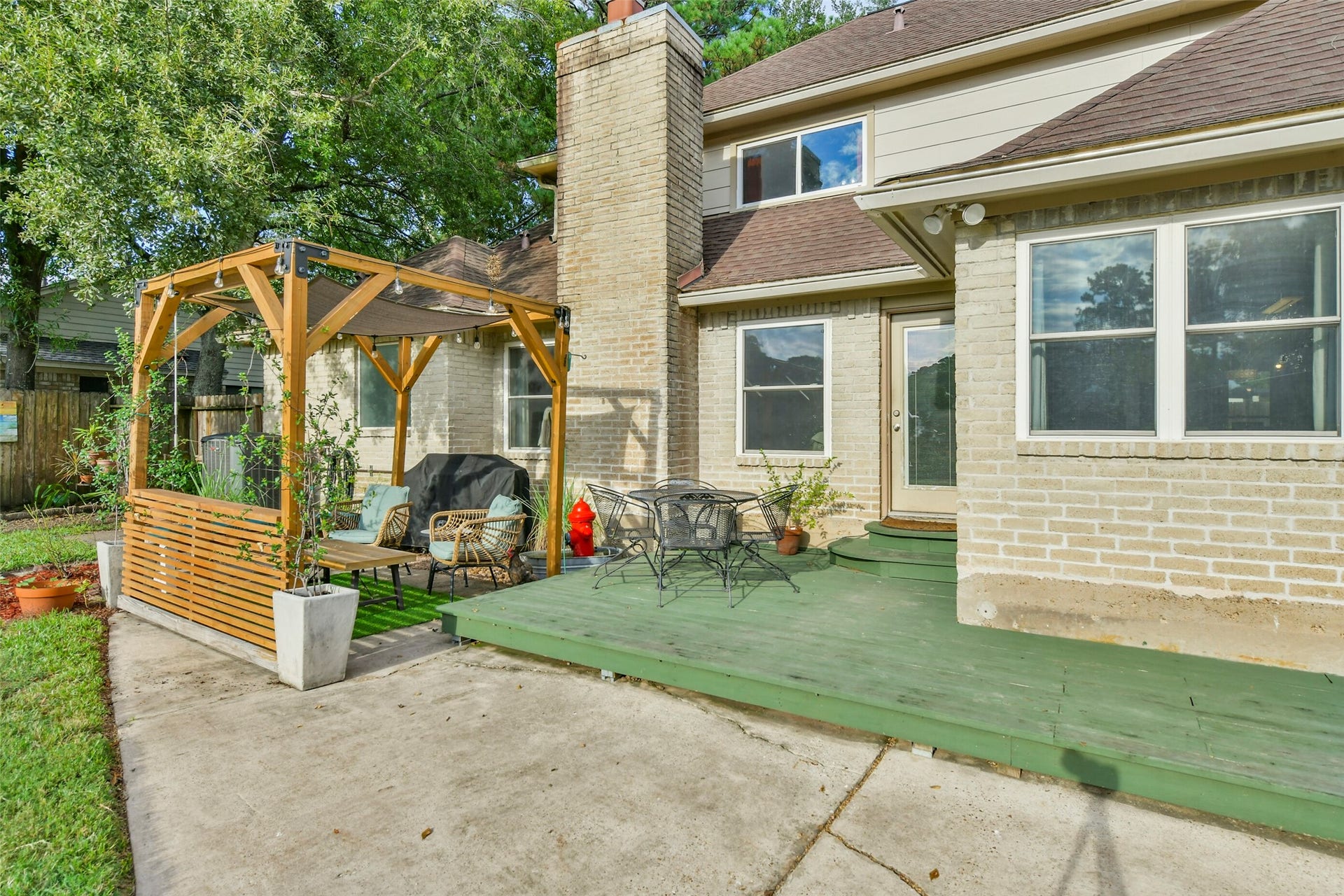 19611 Suncove Lane, Humble, TX 77346 Extend your living space into the fresh air. A deck just outside the home connects to the patio and pergola seating area, creating an easy setup for grilling, dining and relaxed evenings surrounded by backyard greenery.
