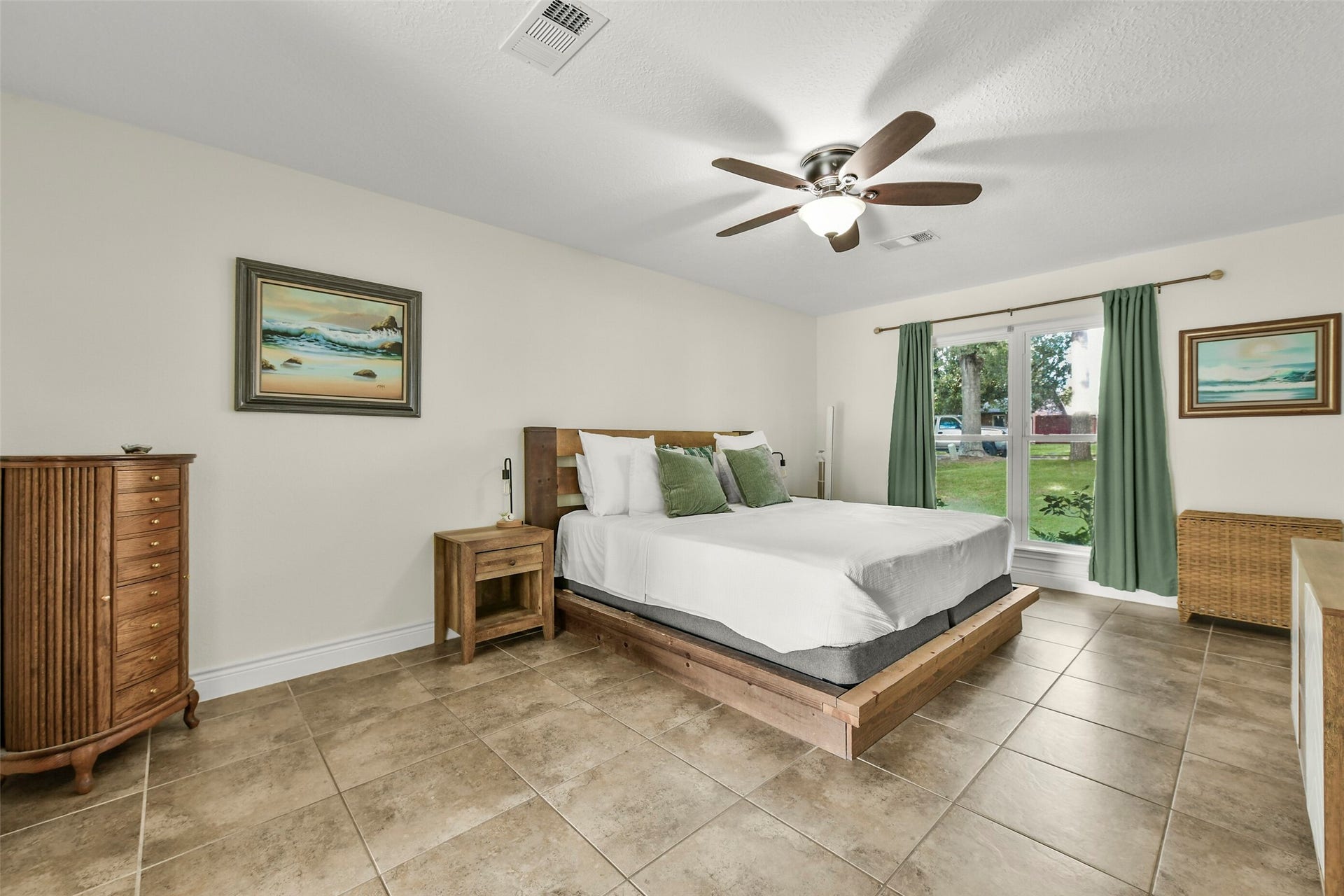 19611 Suncove Lane, Humble, TX 77346 Ease into the day with leafy views and soft natural light. This inviting bedroom offers generous space around the bed, while neutral finishes create a restful backdrop ready for your personal style.
