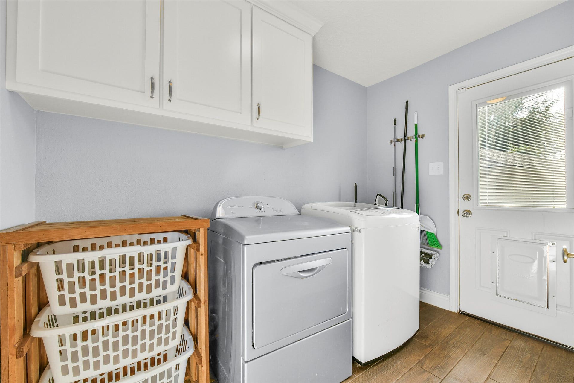 19611 Suncove Lane, Humble, TX 77346 Everyday chores have a dedicated home. Overhead cabinetry keeps supplies organized, while natural light and an exterior door add convenience to this practical laundry space.