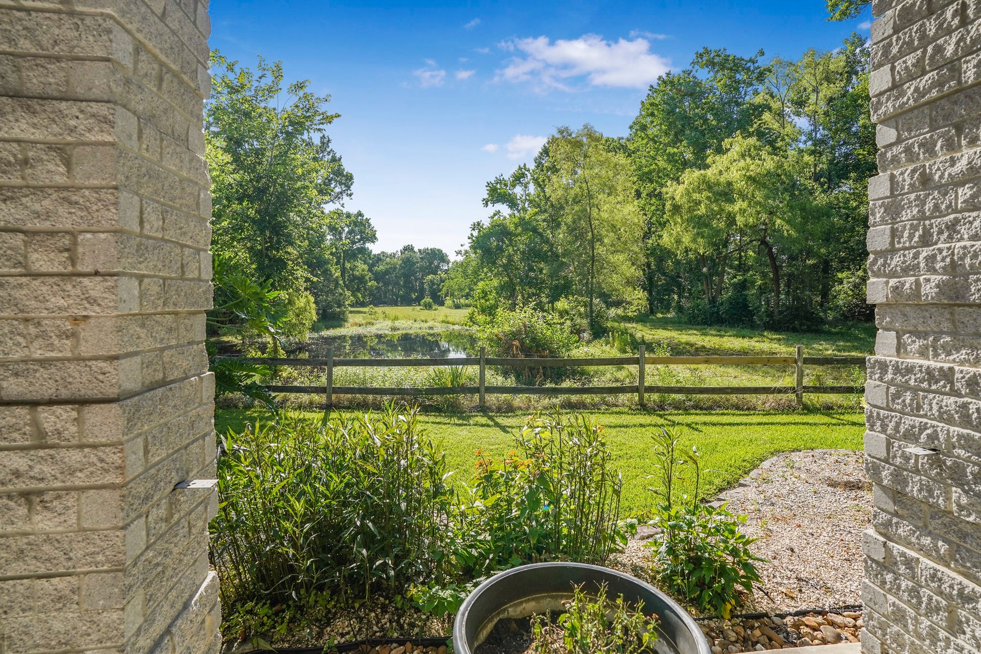 20547 Crosby Eastgate Road, Crosby, TX 77532 A view of the pond in front of the main house.