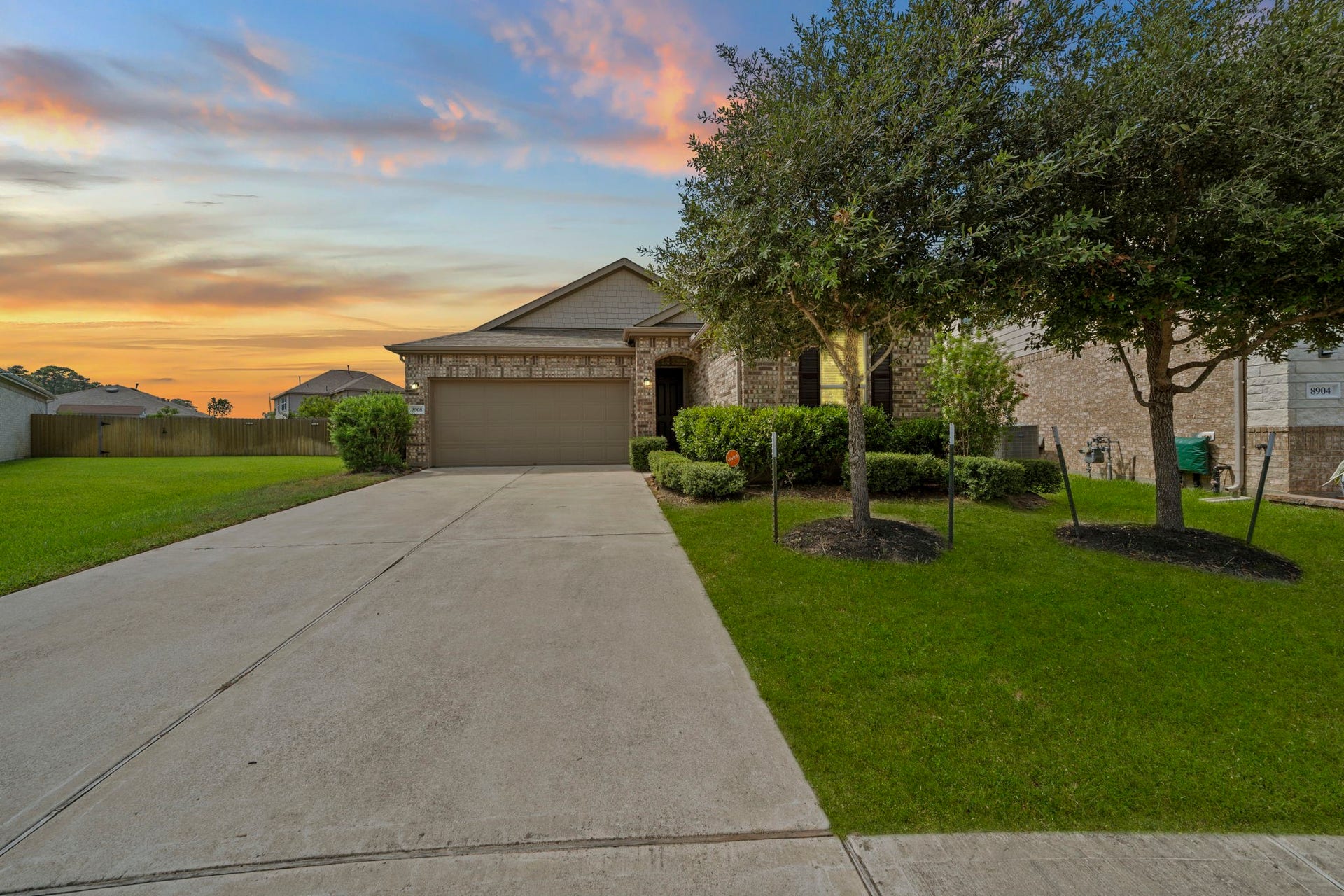 8908 Bear Mountain Court, Magnolia, TX 77354 Charming curb appeal awaits you at this beautiful brick home, featuring mature trees and manicured landscaping. The long, double-wide driveway leads to a two-car garage, offering ample parking.