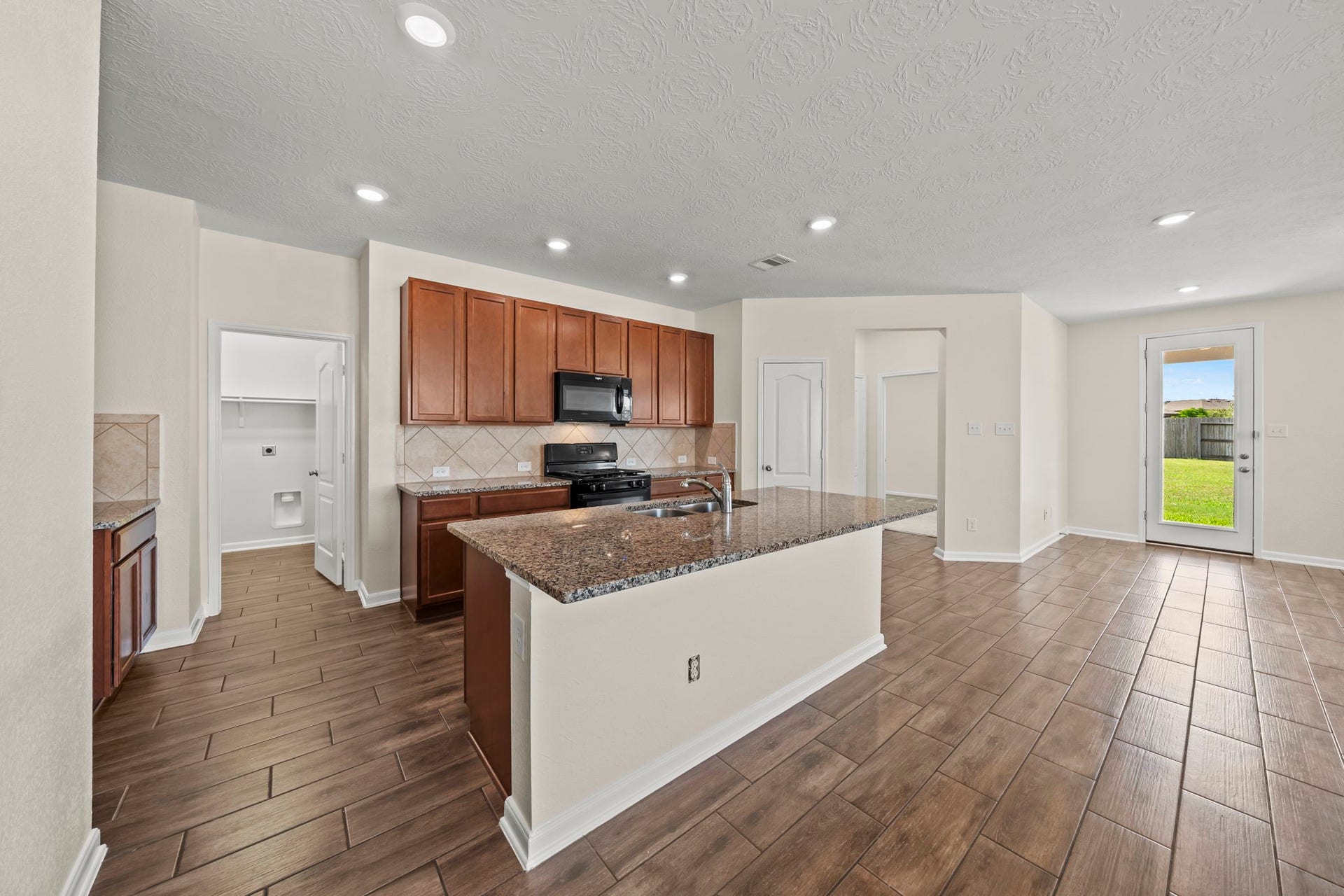 8908 Bear Mountain Court, Magnolia, TX 77354 The open design keeps you connected to friends and family while preparing meals.