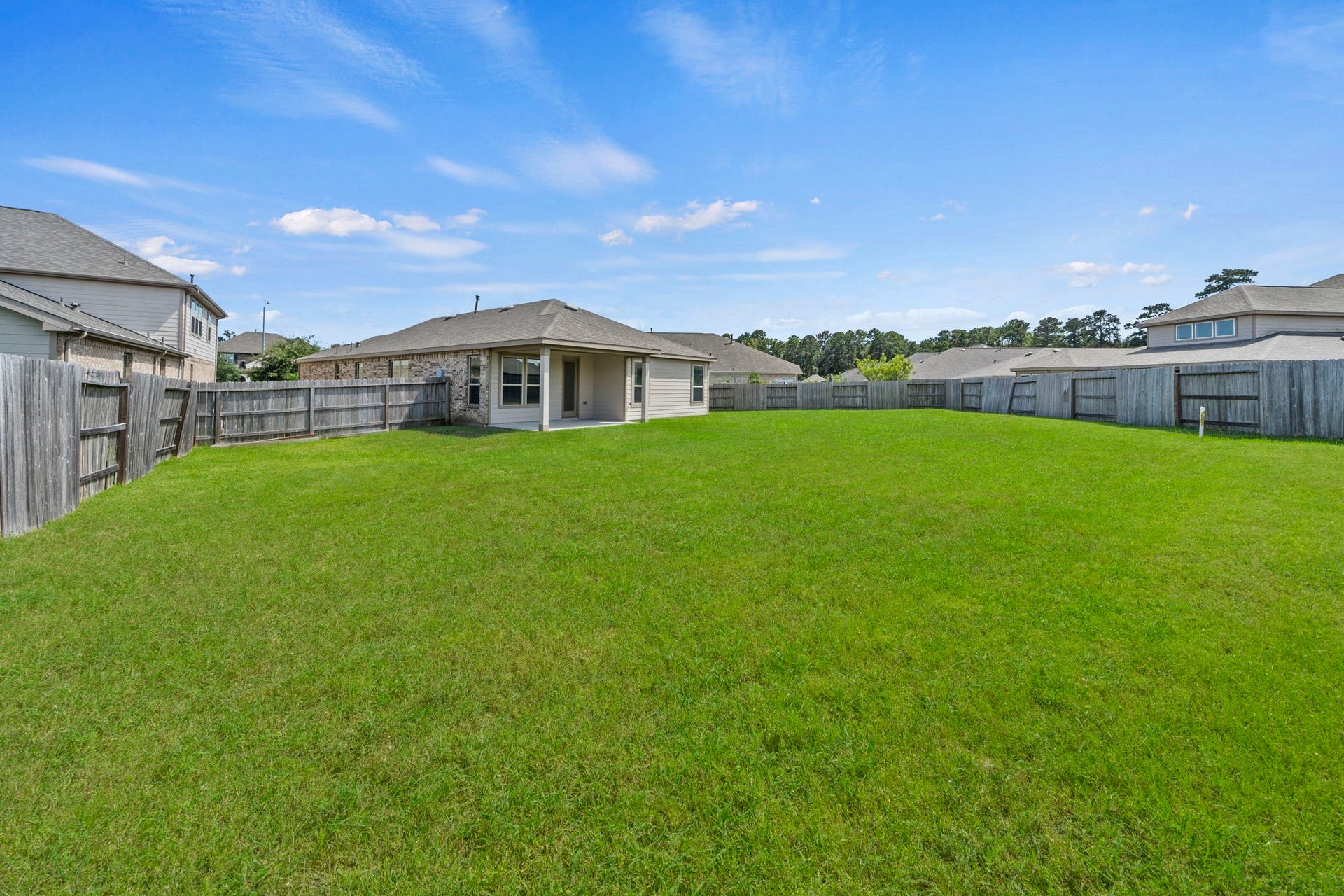 8908 Bear Mountain Court, Magnolia, TX 77354 Expansive, fully fenced backyard offering endless space for pets, play, or adding a future pool.