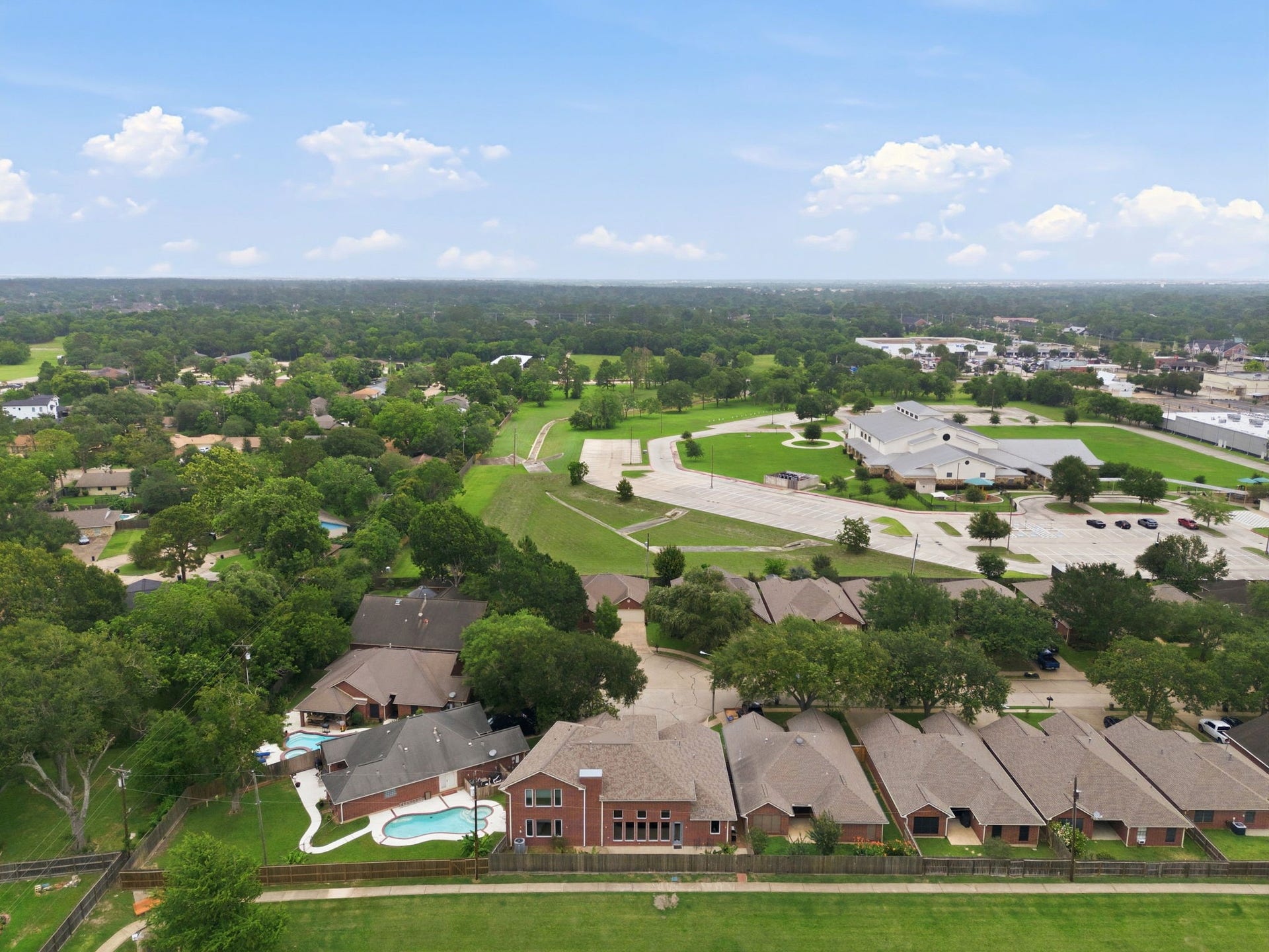 412 Live Oak Lane, Friendswood, TX 77546 Tucked away behind the property, this expansive green space and walking loop offers a serene, retreat with minimal foot traffic.