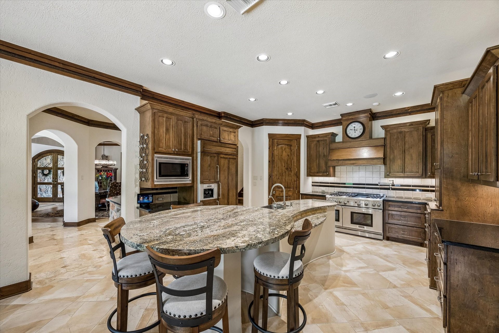 32102 Fulbrook Commons, Fulshear, TX 77441 A generously sized island provides ample prep space while serving as a natural gathering spot at the center of the home. High end luxury appliances included. Refrigerator has cabinet paneled front. Pot filler, home management desk, Thermador gas range, double ovens