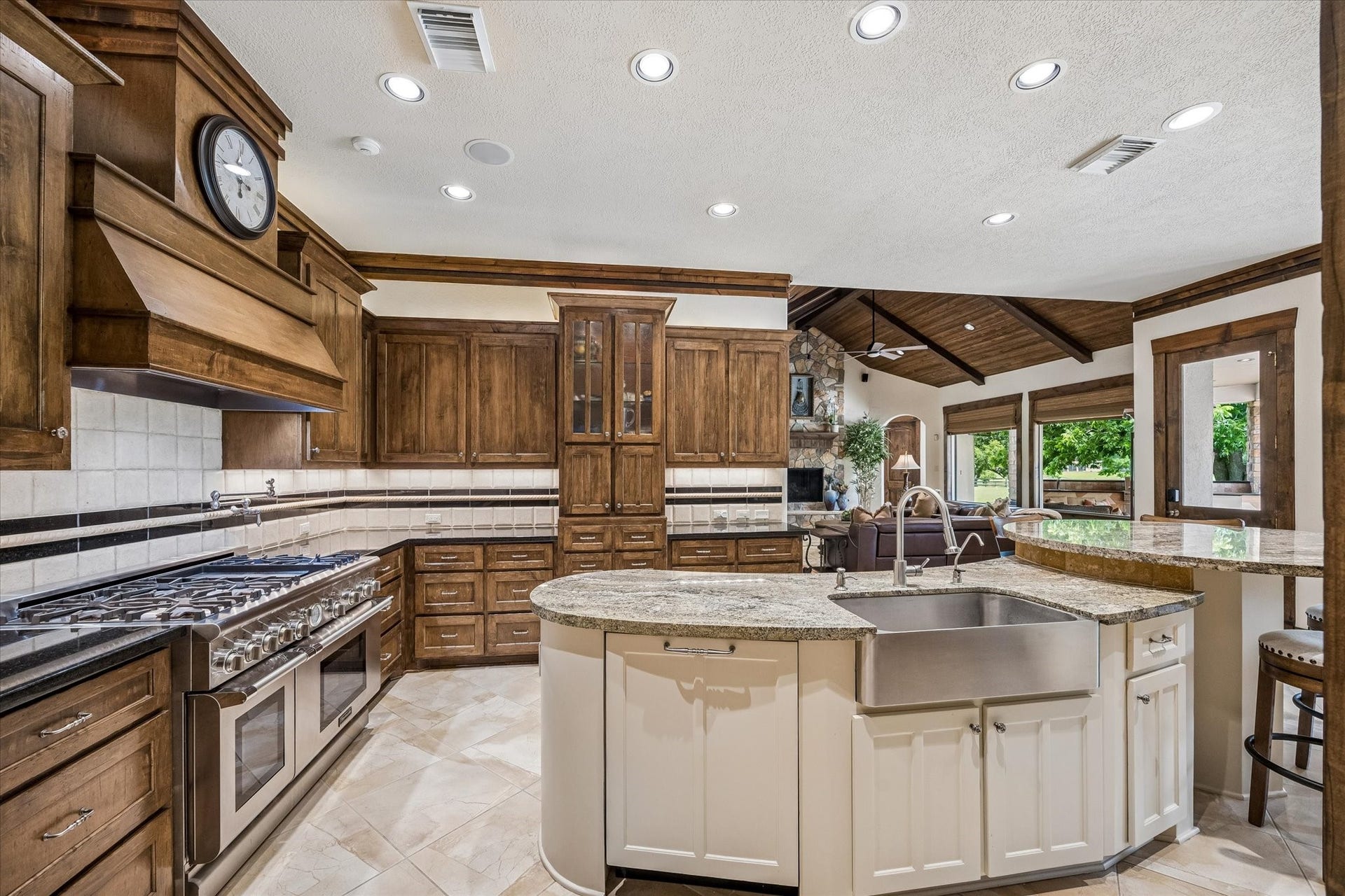 32102 Fulbrook Commons, Fulshear, TX 77441 Designed for both everyday living and entertaining, the kitchen features abundant custom cabinetry, expansive granite surfaces, and professional-grade appliances. Dishwasher with cabinet panel front.