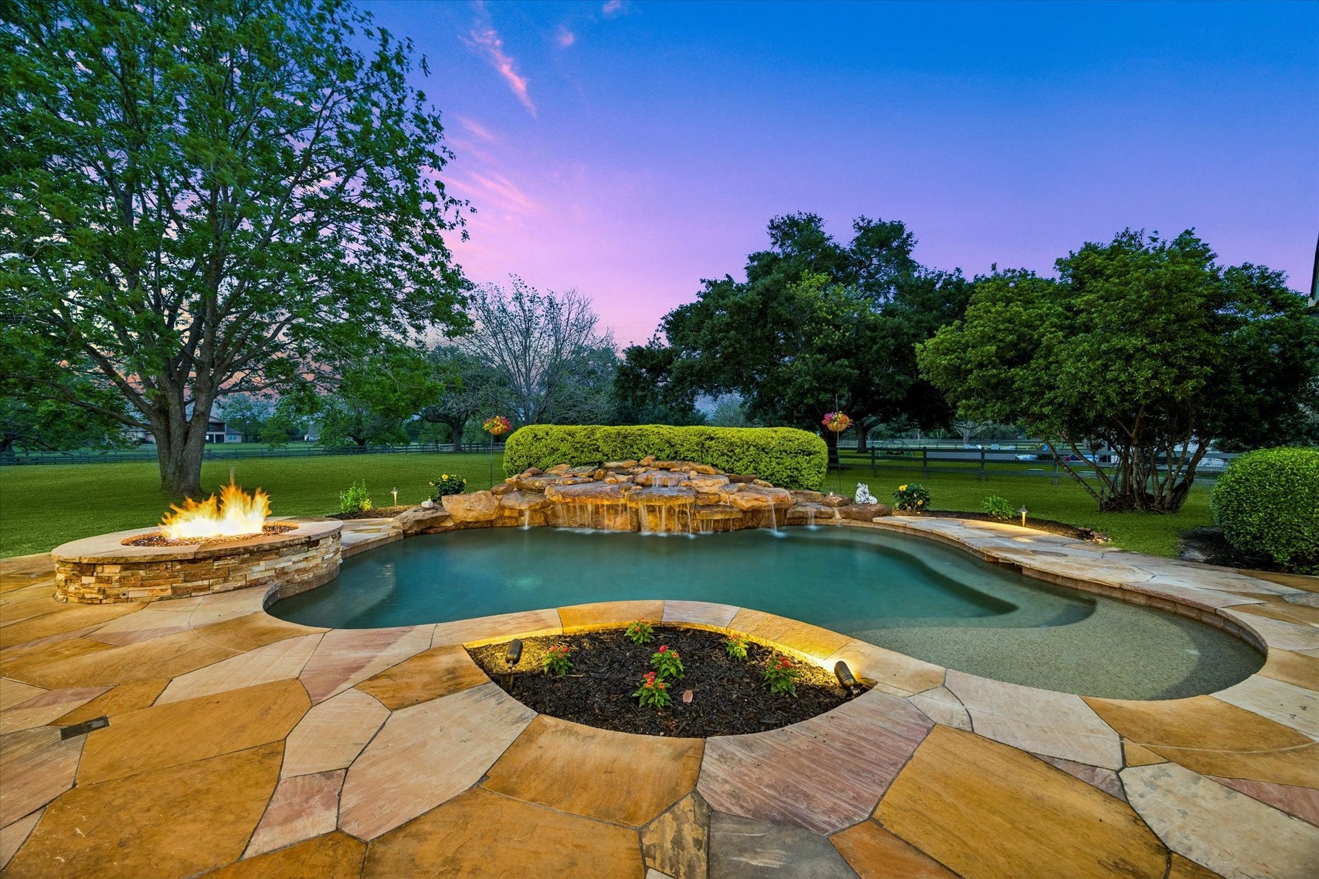 32102 Fulbrook Commons, Fulshear, TX 77441 A custom heated spa with cascading waterfall and integrated fire feature serves as the stunning centerpiece of this beautifully landscaped outdoor oasis.