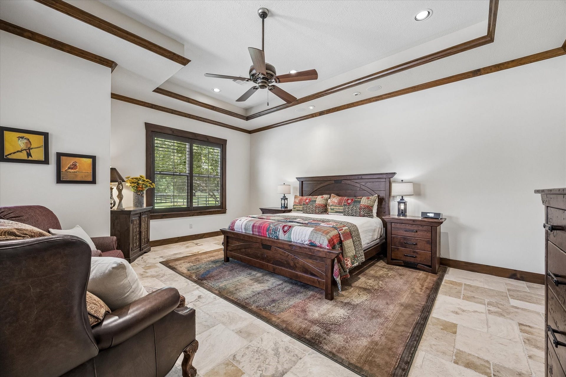 32102 Fulbrook Commons, Fulshear, TX 77441 The spacious primary suite offers a peaceful retreat with elegant ceiling details and serene views of the surrounding property. Wood window frames, tray ceiling, and sitting area are all features that puts this home a step above the rest.