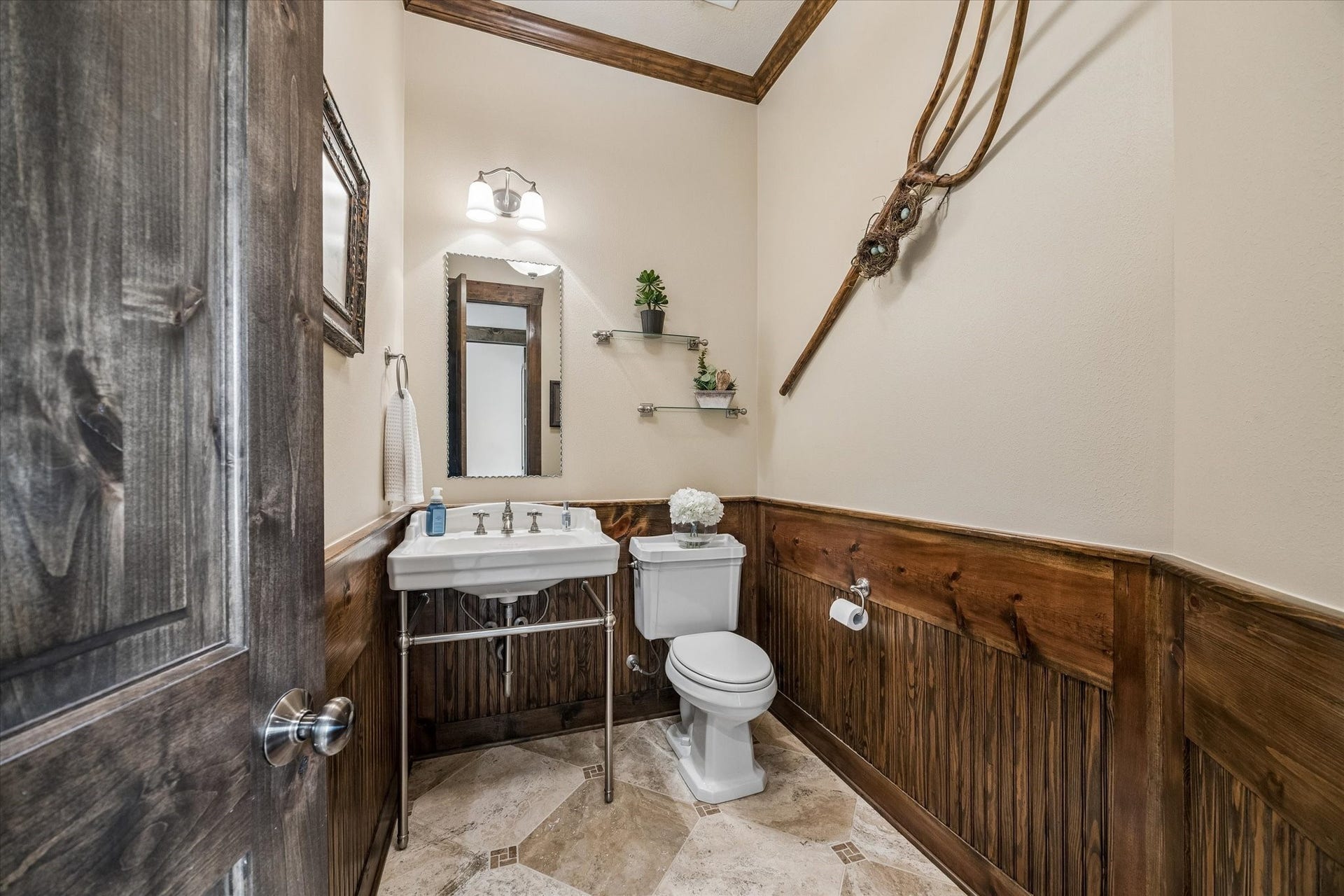 32102 Fulbrook Commons, Fulshear, TX 77441 Conveniently located for guests, this charming powder room showcases warm wood accents and finishes that complement the home's custom character.