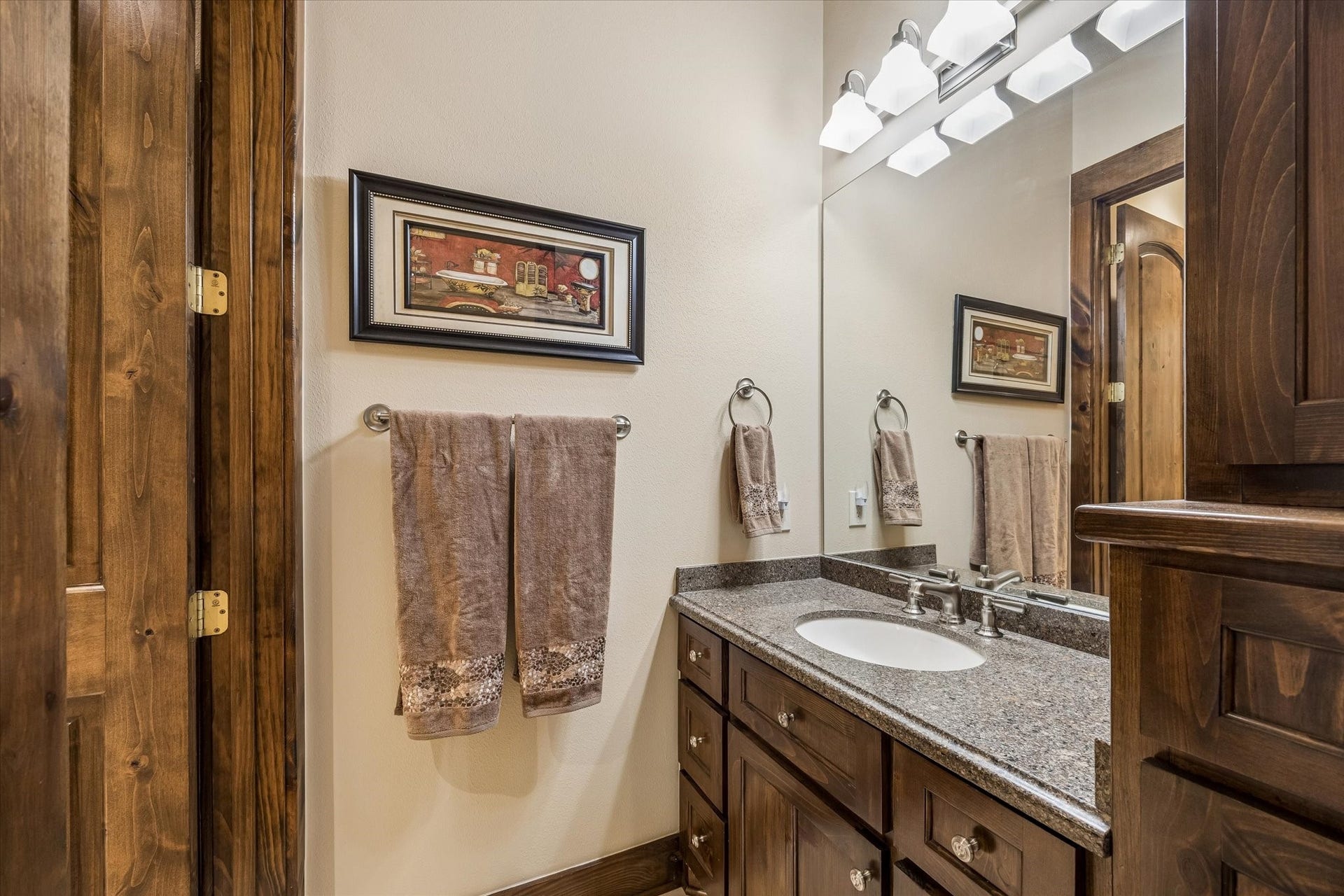 32102 Fulbrook Commons, Fulshear, TX 77441 A granite-topped vanity and warm wood cabinetry provide both style and everyday functionality