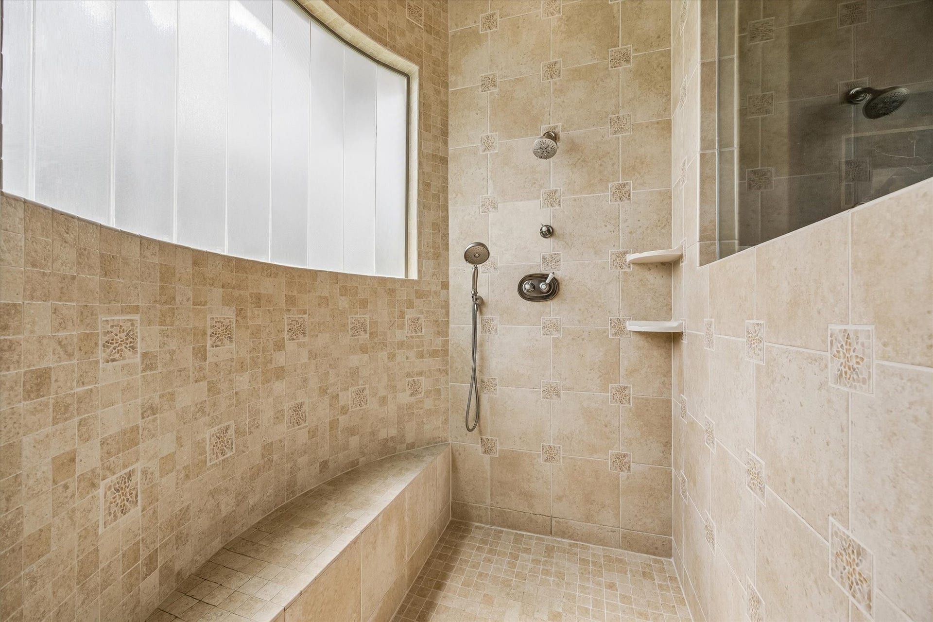 32102 Fulbrook Commons, Fulshear, TX 77441 The oversized walk-in shower showcases timeless tilework, built-in seating, and a bright window for natural light.
