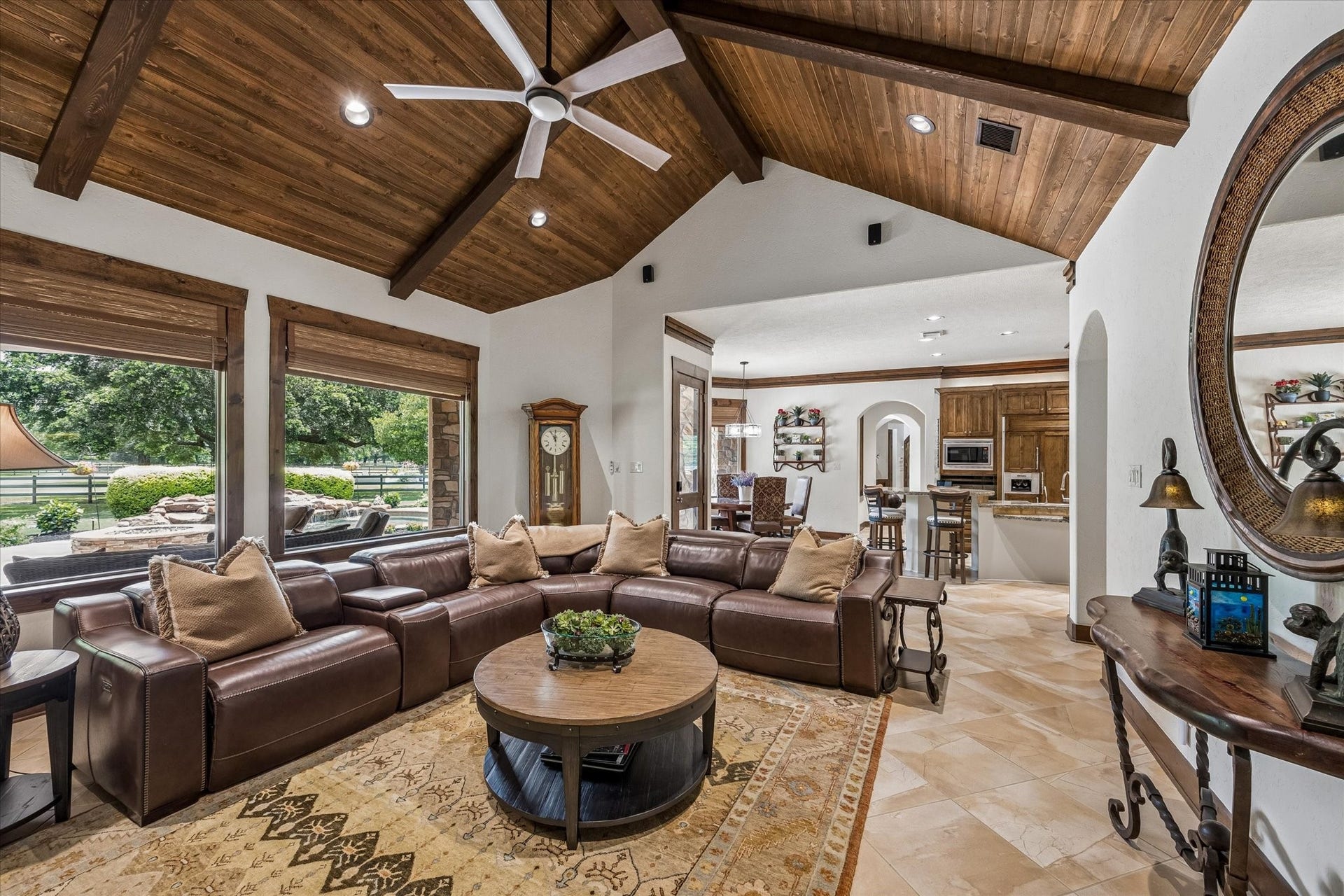 32102 Fulbrook Commons, Fulshear, TX 77441 Expansive windows fill the space with natural light while seamlessly connecting indoor living to the outdoor setting. The wood ceiling with beams is the showstopper in this gorgeous space.
