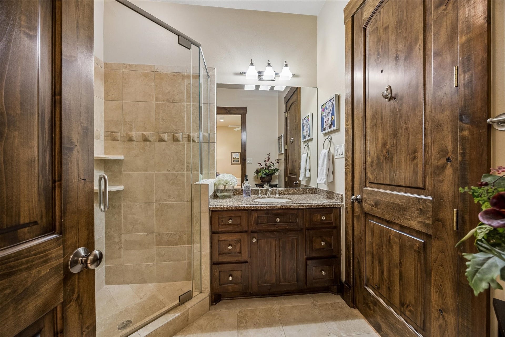 32102 Fulbrook Commons, Fulshear, TX 77441 A glass-enclosed shower and abundant storage enhance the thoughtful design of this private bath.
