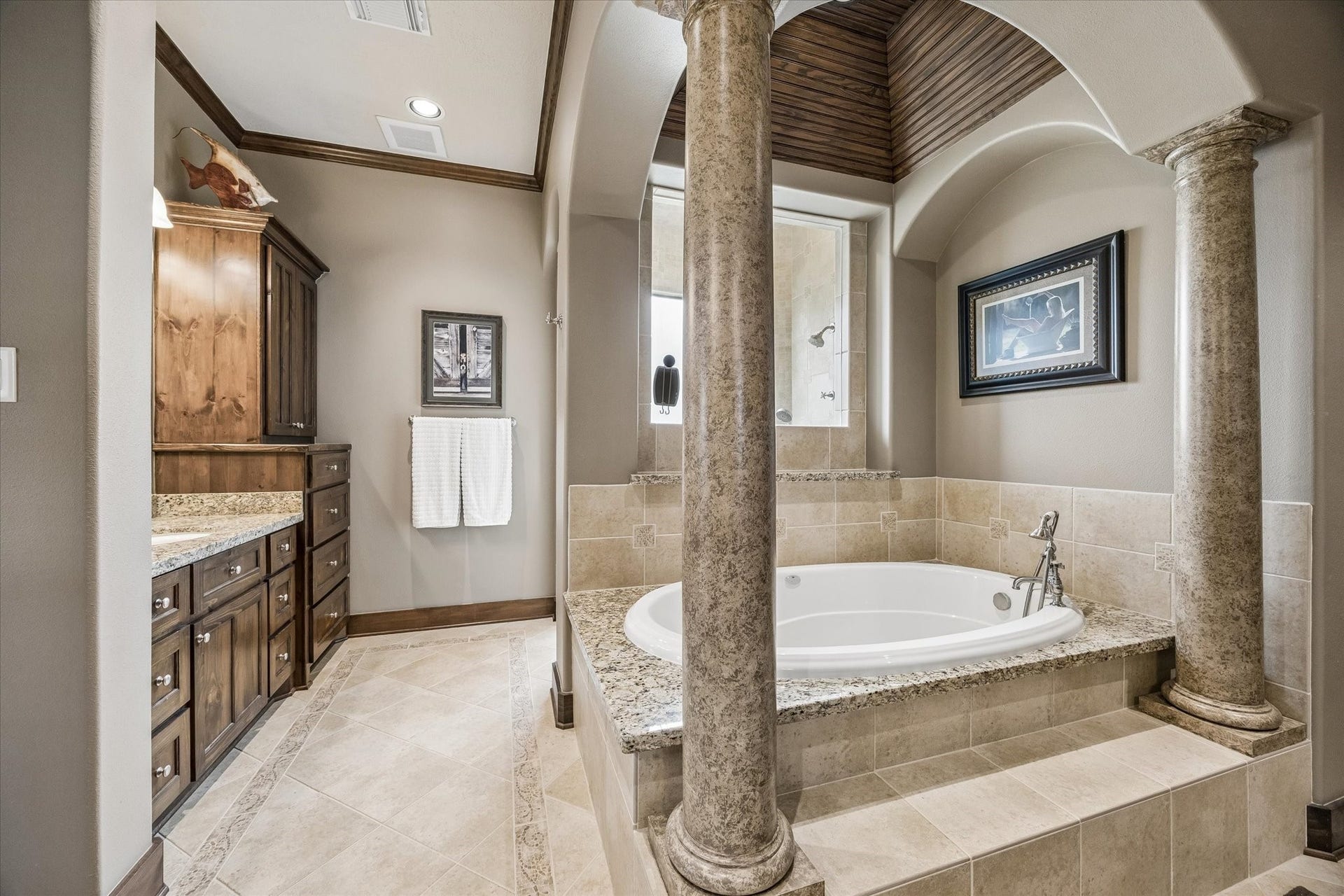 32102 Fulbrook Commons, Fulshear, TX 77441 Framed by decorative columns and architectural archways, the grand soaking tub creates a true spa-inspired focal point.