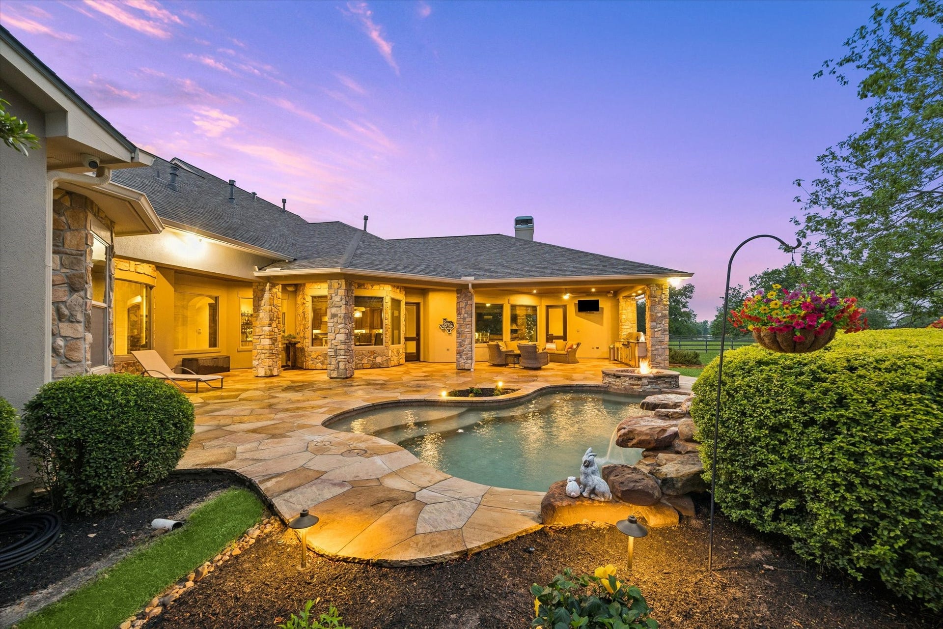 32102 Fulbrook Commons, Fulshear, TX 77441 Thoughtfully designed for both everyday enjoyment and memorable gatherings, this backyard oasis features a custom pool, elegant stonework, and inviting outdoor living areas.