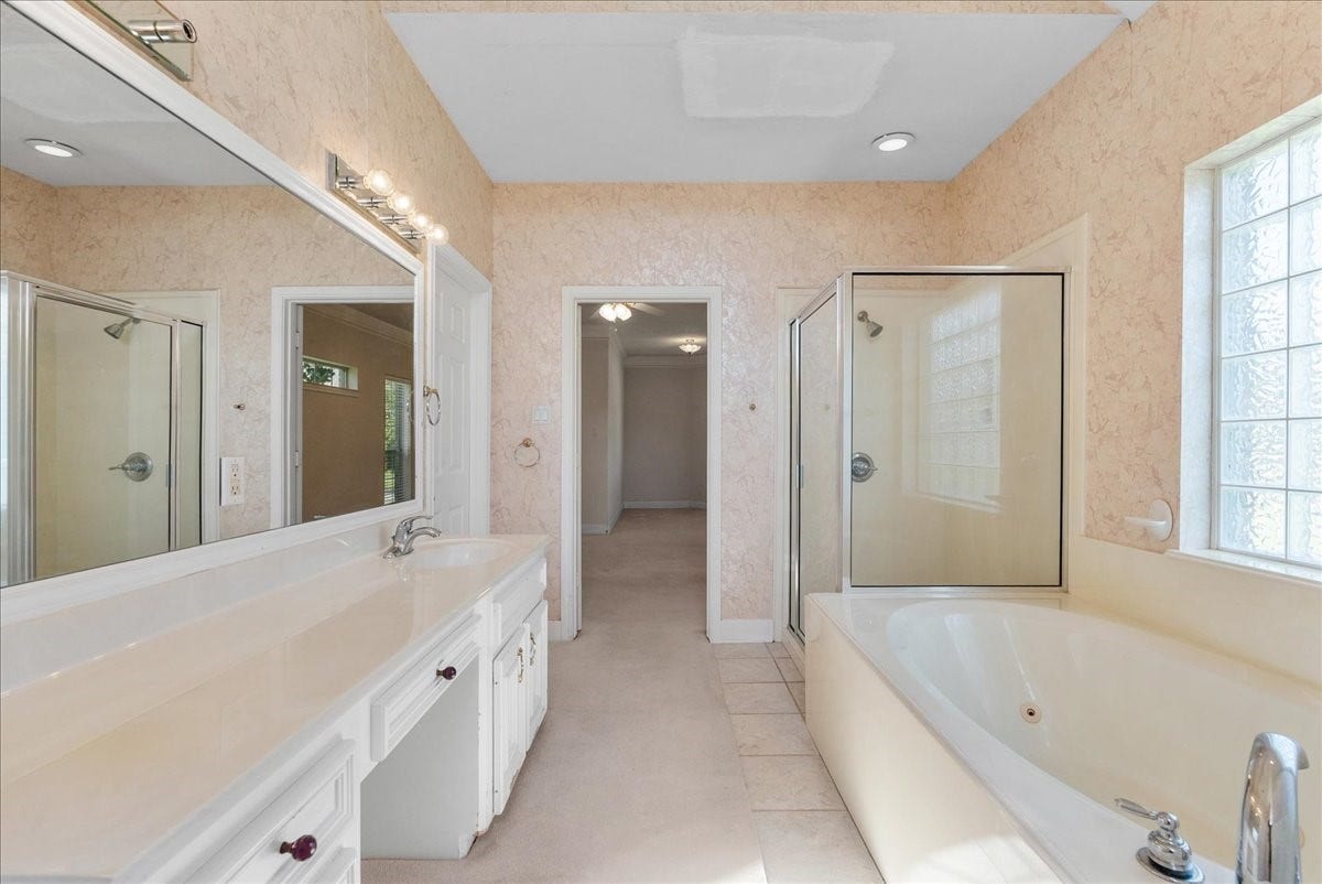 4402 Santee Drive, Baytown, TX 77521 A deep jetted soaking tub provides an indulgent spot to decompress after long days.