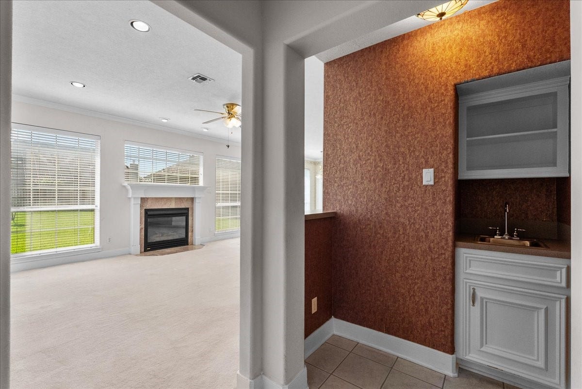 4402 Santee Drive, Baytown, TX 77521 Conveniently situated just steps from the living room, this dedicated wet bar with built-in cabinetry and a bar sink makes entertaining seamless.