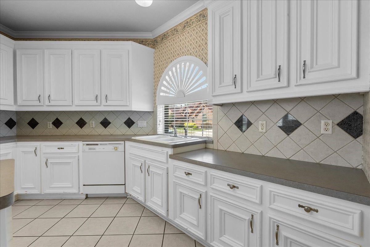 4402 Santee Drive, Baytown, TX 77521 An arched window directly over the double-basin sink pours cheerful natural daylight across the workspace.