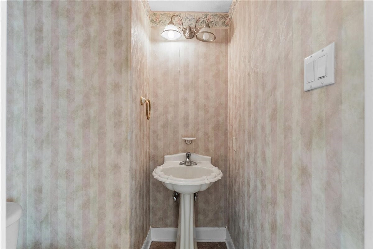 4402 Santee Drive, Baytown, TX 77521 This dedicated first-floor powder room provides essential convenience for guests.