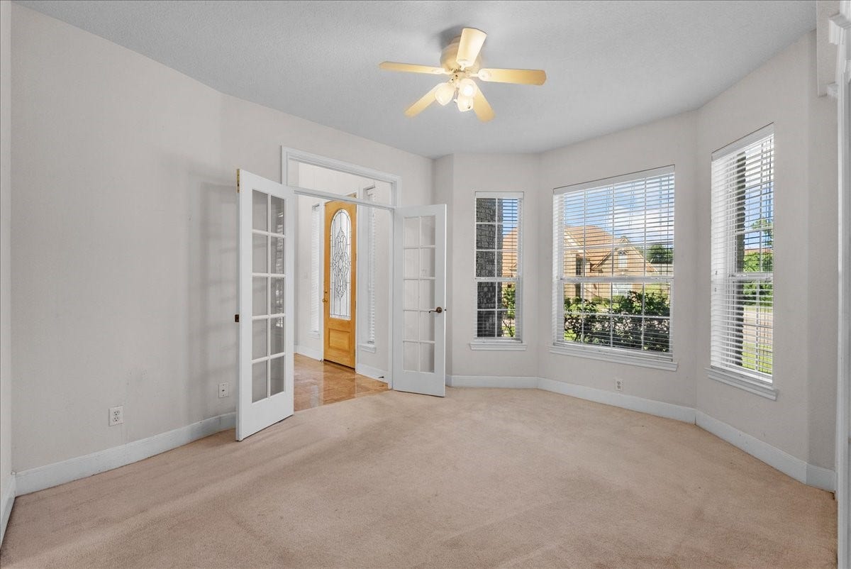 4402 Santee Drive, Baytown, TX 77521 Double French doors open to this versatile front room, ideal for an executive home office, study, or quiet formal living space.