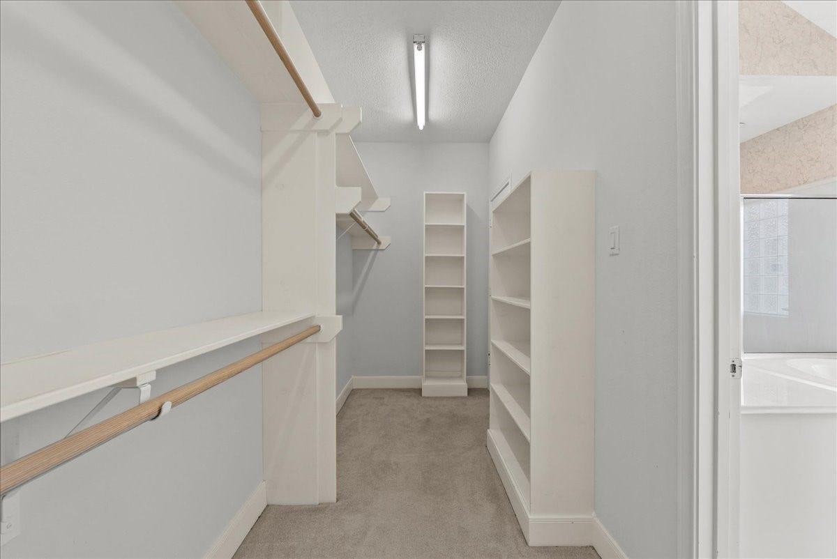 4402 Santee Drive, Baytown, TX 77521 Custom floor-to-ceiling shelving units and tiered hanging rails maximize every square foot of storage.