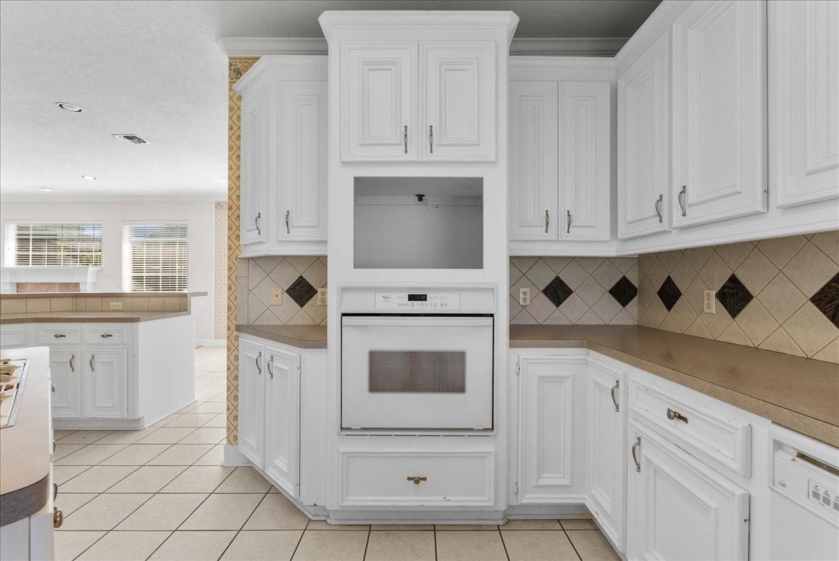 4402 Santee Drive, Baytown, TX 77521 Stacking the built-in oven and dedicated microwave alcove vertically frees up valuable counter space.