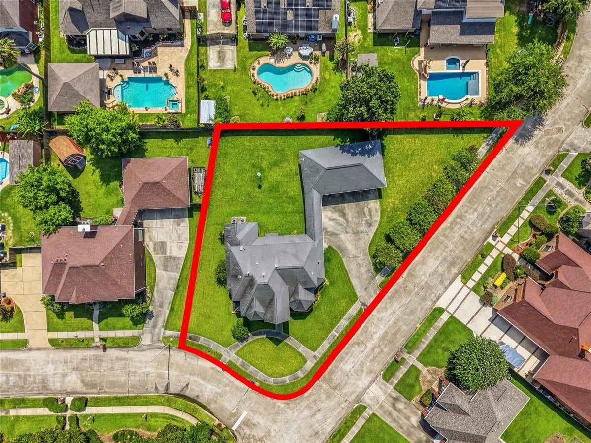 4402 Santee Drive, Baytown, TX 77521 Aerial property view illustrating the generous lot boundaries, extensive driveway parking, and prime corner placement within Country Club Oaks.
