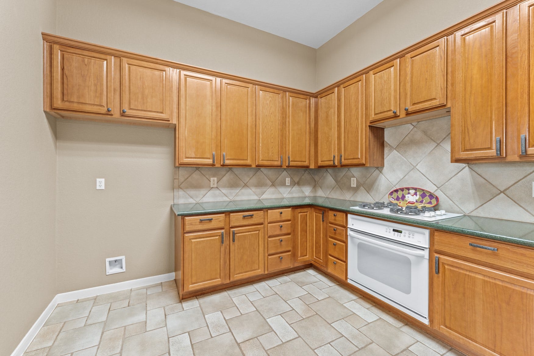 16503 Oat Mill Drive, Houston, TX 77095 Beautiful 42-inch wood cabinets line the walls of the kitchen and hammered metal hardware adorn the drawers and cabinet doors. Note the lazy-susan cabinet in the corner!