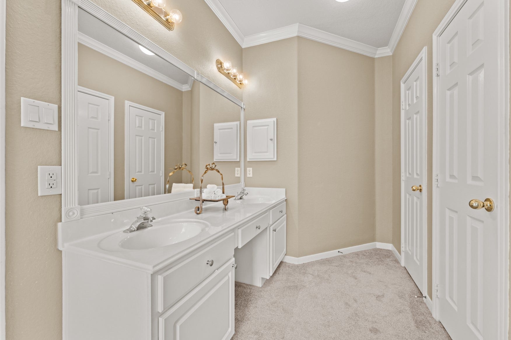 16503 Oat Mill Drive, Houston, TX 77095 The primary bathroom also features double sinks and cabinetry with a vanity area in the middle, a long framed mirror, linen storage and a private WC.