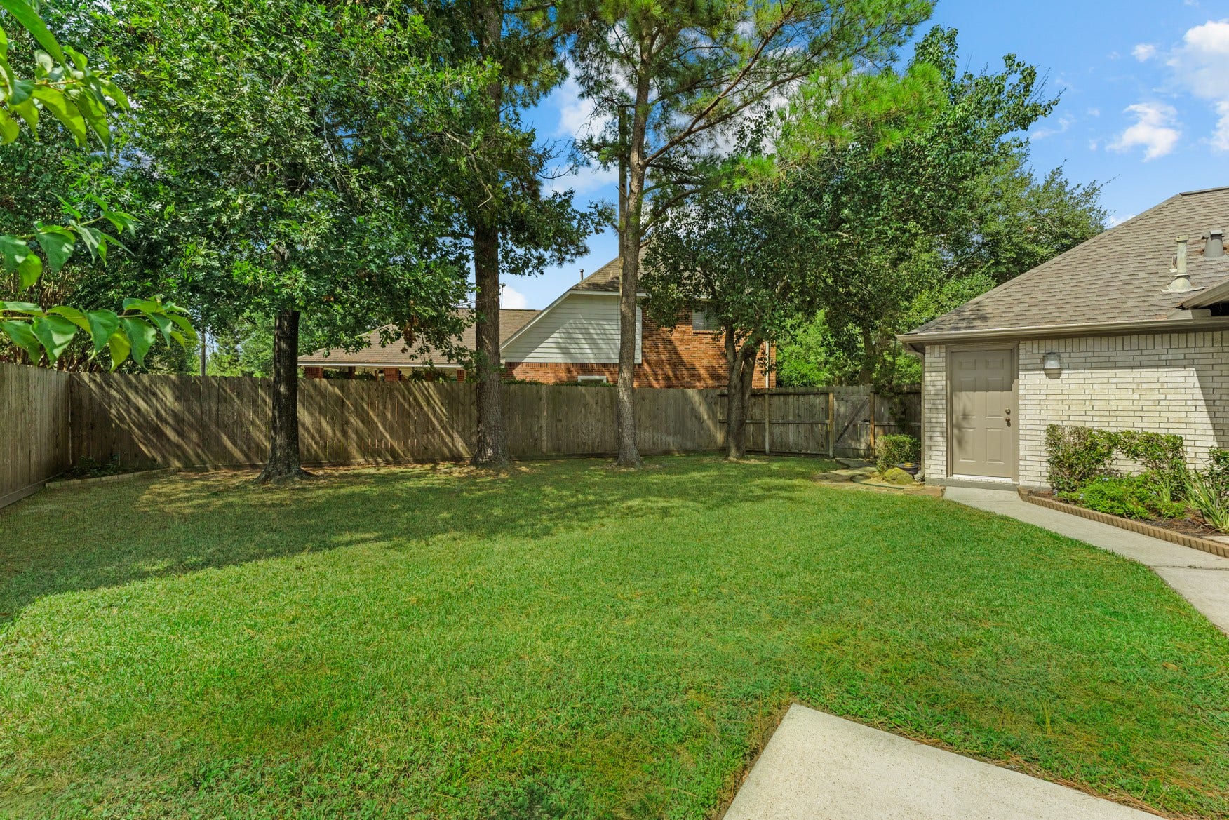 16503 Oat Mill Drive, Houston, TX 77095 One of TWO huge lawn areas in your backyard! The door on the right leads to the garage.
