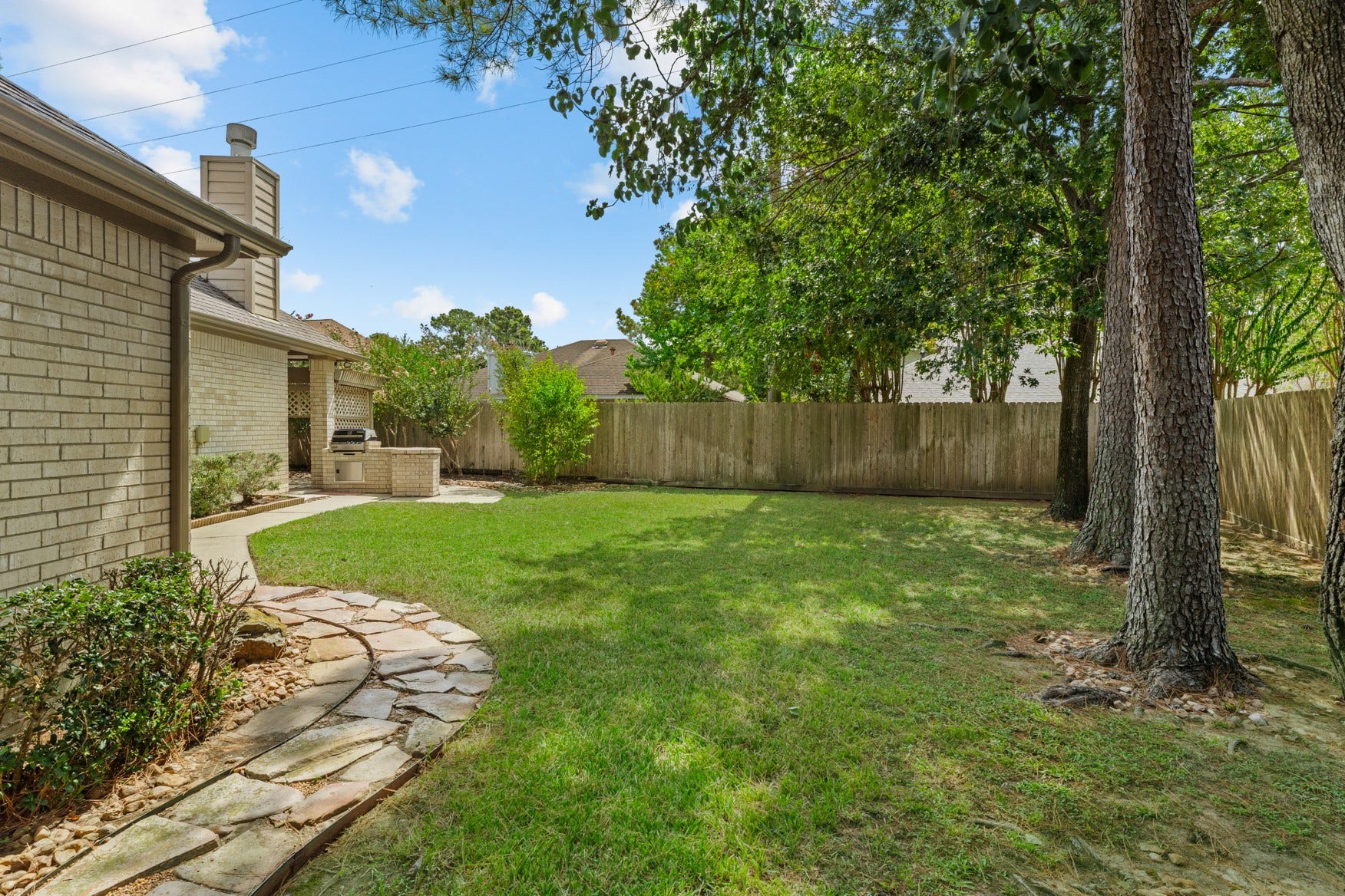 16503 Oat Mill Drive, Houston, TX 77095 Stone pathways and neat edging add to the charm of this property.