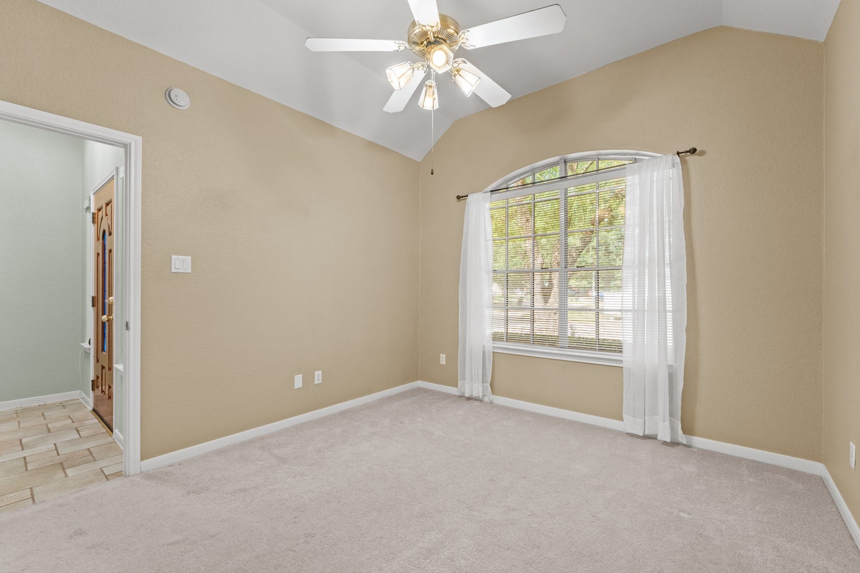 16503 Oat Mill Drive, Houston, TX 77095 This is the first guest bedroom featuring a wide arched window overlooking the front yard and a high vaulted ceiling. This room would also make a great office with a nice view!