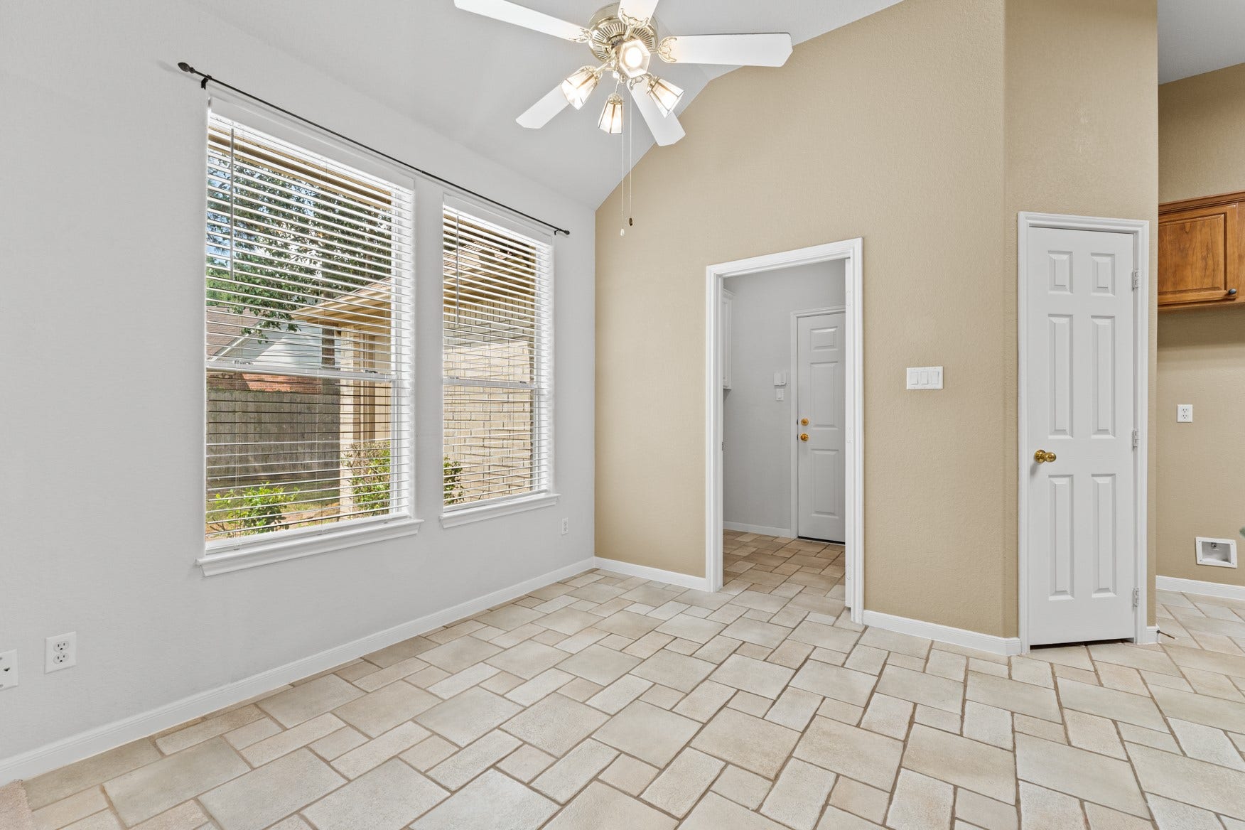 16503 Oat Mill Drive, Houston, TX 77095 Enjoy meals in this cheery, sunny breakfast area with a view of the huge yard. The doorway in the center leads to the laundry room and 3-car garage.