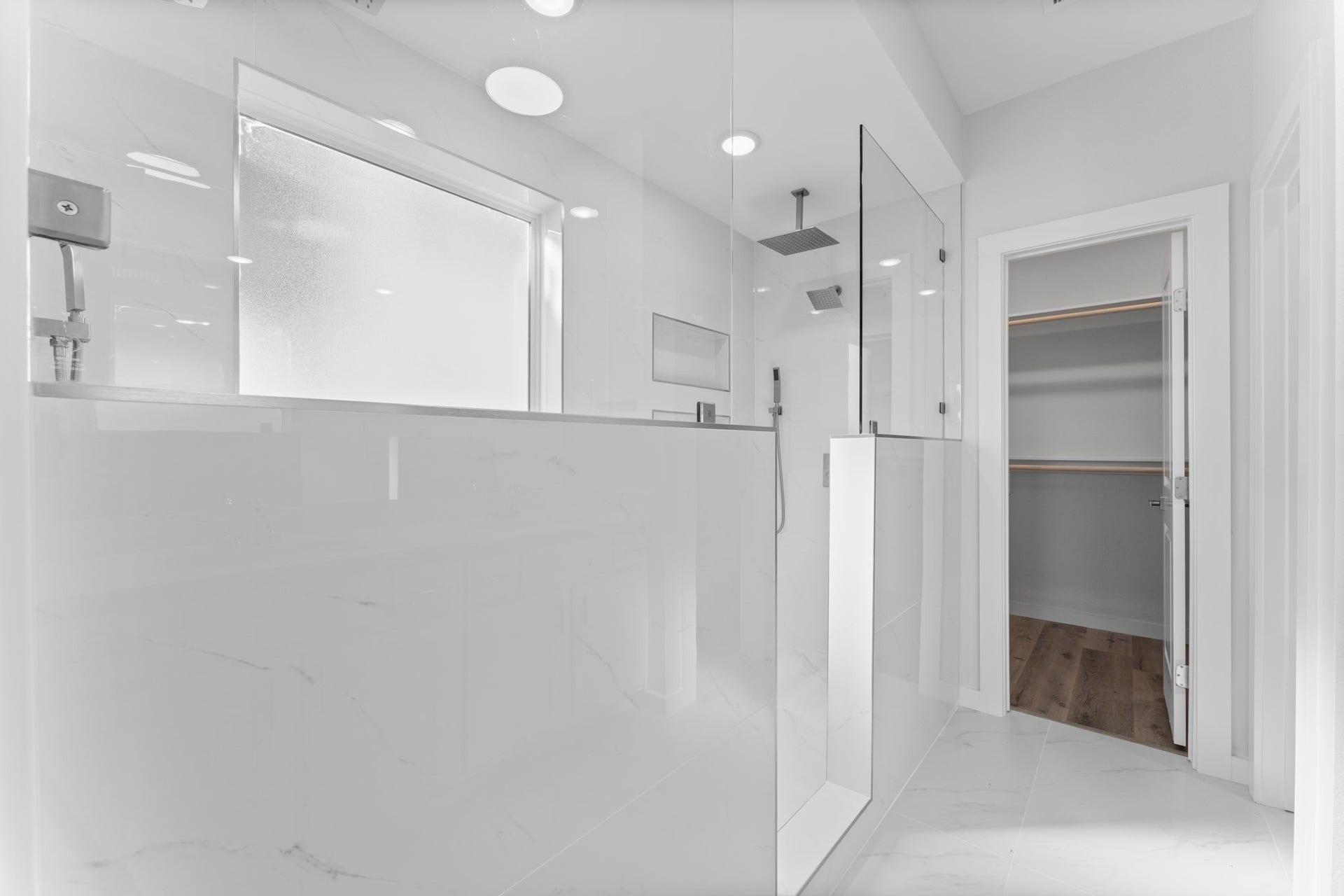 2230 Fresh Flower Way, Richmond, TX 77406 Indulge in a massive walk-in shower wrapped in stunning marble-look porcelain tile. It features a designer rainfall showerhead, a separate handheld wand, and dual built-in niches for a spa-like experience.