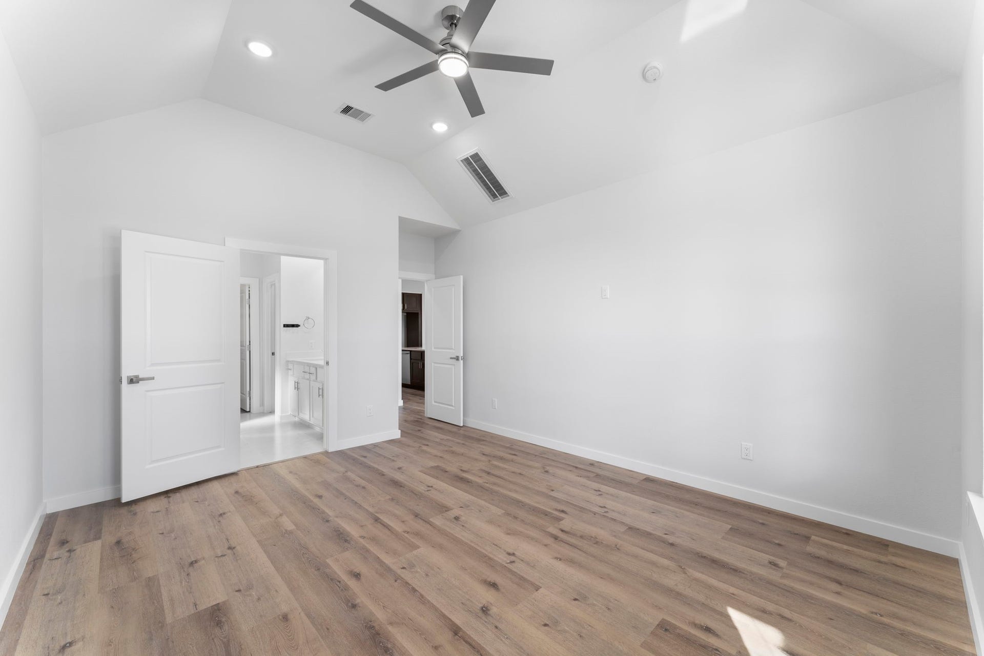 2230 Fresh Flower Way, Richmond, TX 77406 The spacious primary bedroom features premium upgraded flooring, creating an airy and sophisticated atmosphere. Its a perfectly serene space designed for rest and relaxation.