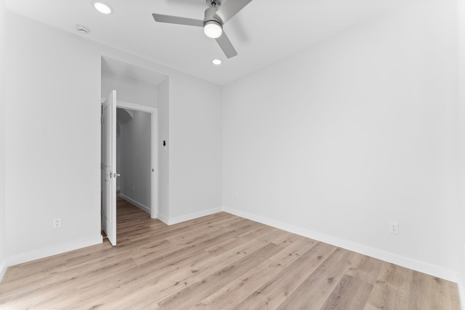 2230 Fresh Flower Way, Richmond, TX 77406 Clean & Quiet. Highlighting the home's commitment to quality, this view shows the flawless finish work, from the modern door hardware to the crisp baseboards and recessed lighting.