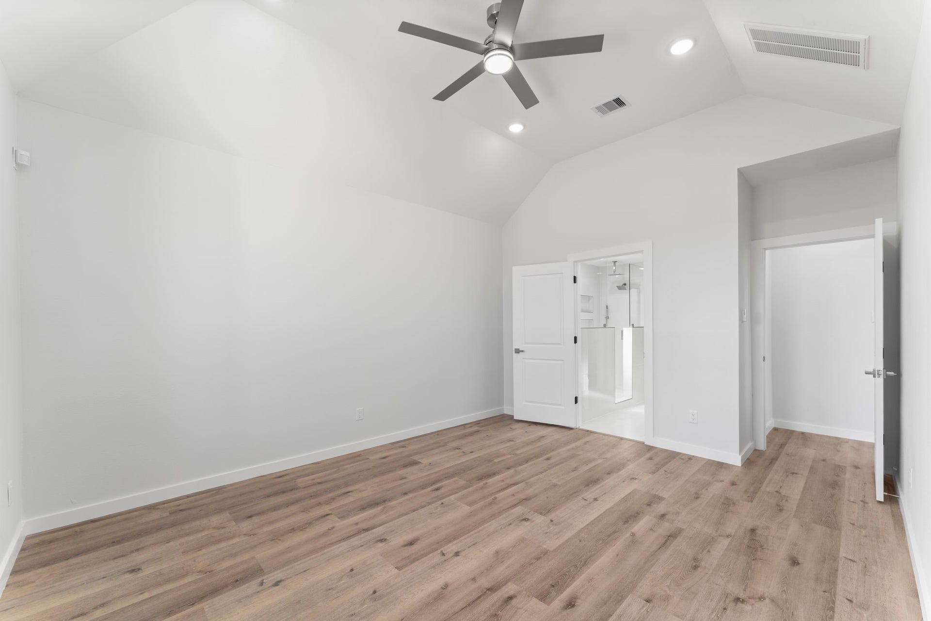 2230 Fresh Flower Way, Richmond, TX 77406 Double doors lead from the sleeping quarters directly into the spa-like primary bathroom, emphasizing the suites thoughtful, open layout.