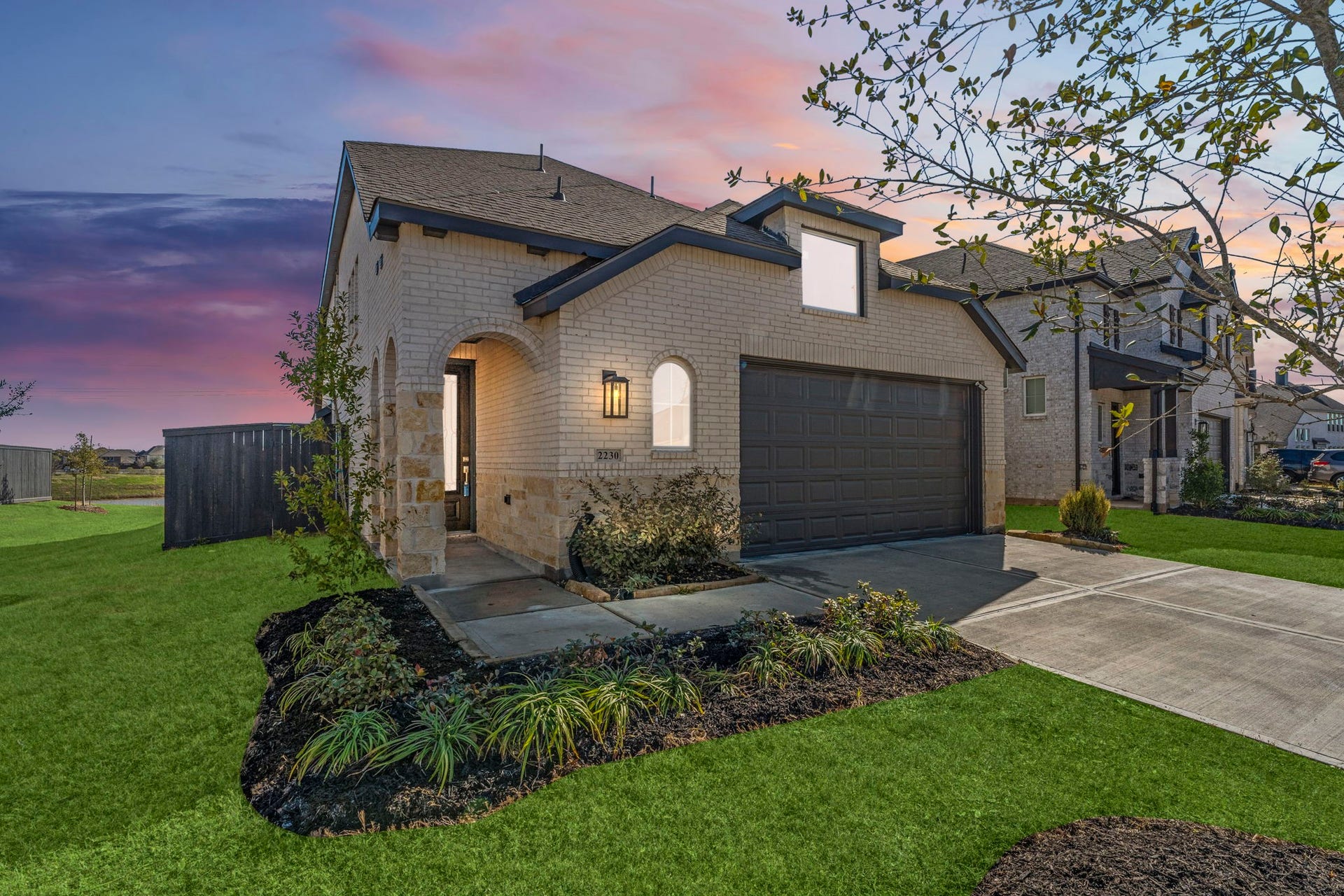 2230 Fresh Flower Way, Richmond, TX 77406 Welcome home to this stunning modern build. The light brick exterior glows, highlighting the clean lines, spacious two-car garage, and professional landscaping that creates instant curb appeal.