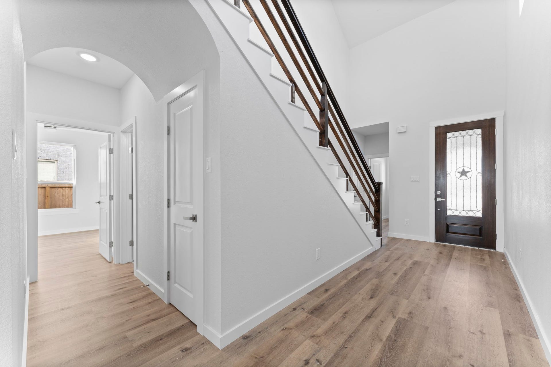 2230 Fresh Flower Way, Richmond, TX 77406 Sophisticated Spaces. This view of the foyer highlights the immense natural light and the architectural excellence of the home. The clean white walls serve as a perfect gallery space for your personal style.