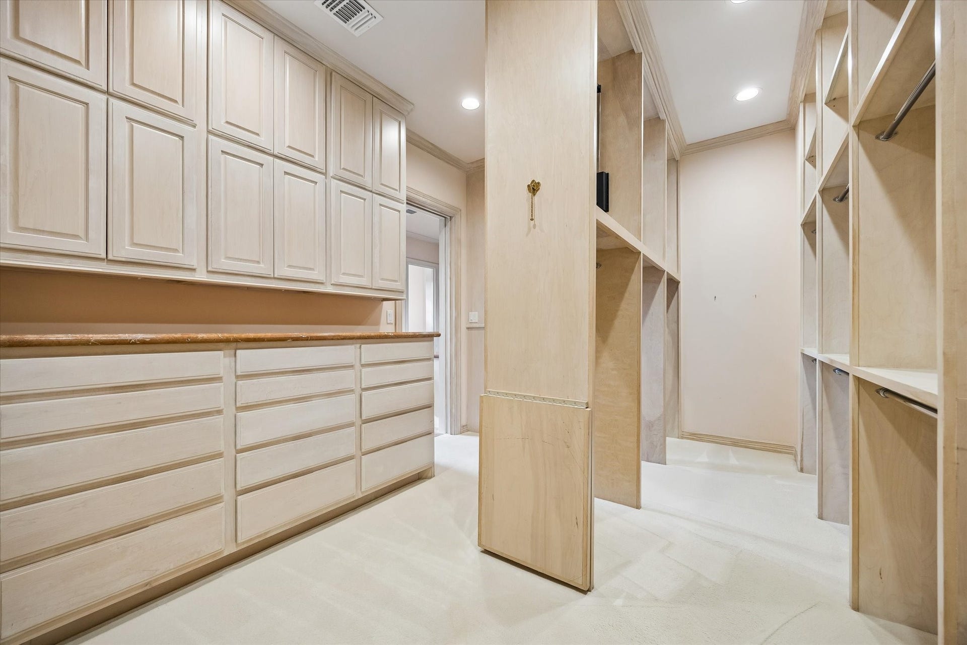 22 Eaton Square, Houston, TX 77027 Walk-in closet measuring 21 x 10 with generous hanging space, built ins, as well as shoe and handbag storage.