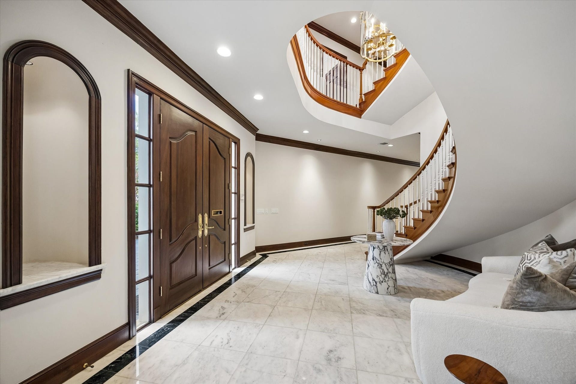 22 Eaton Square, Houston, TX 77027 Elegant formal entry sets the tone for what to expect as you walk into this luxurious home with white Carrera marble flooring and grand circular stairway as well as art niches on each side of the double entry front doors.