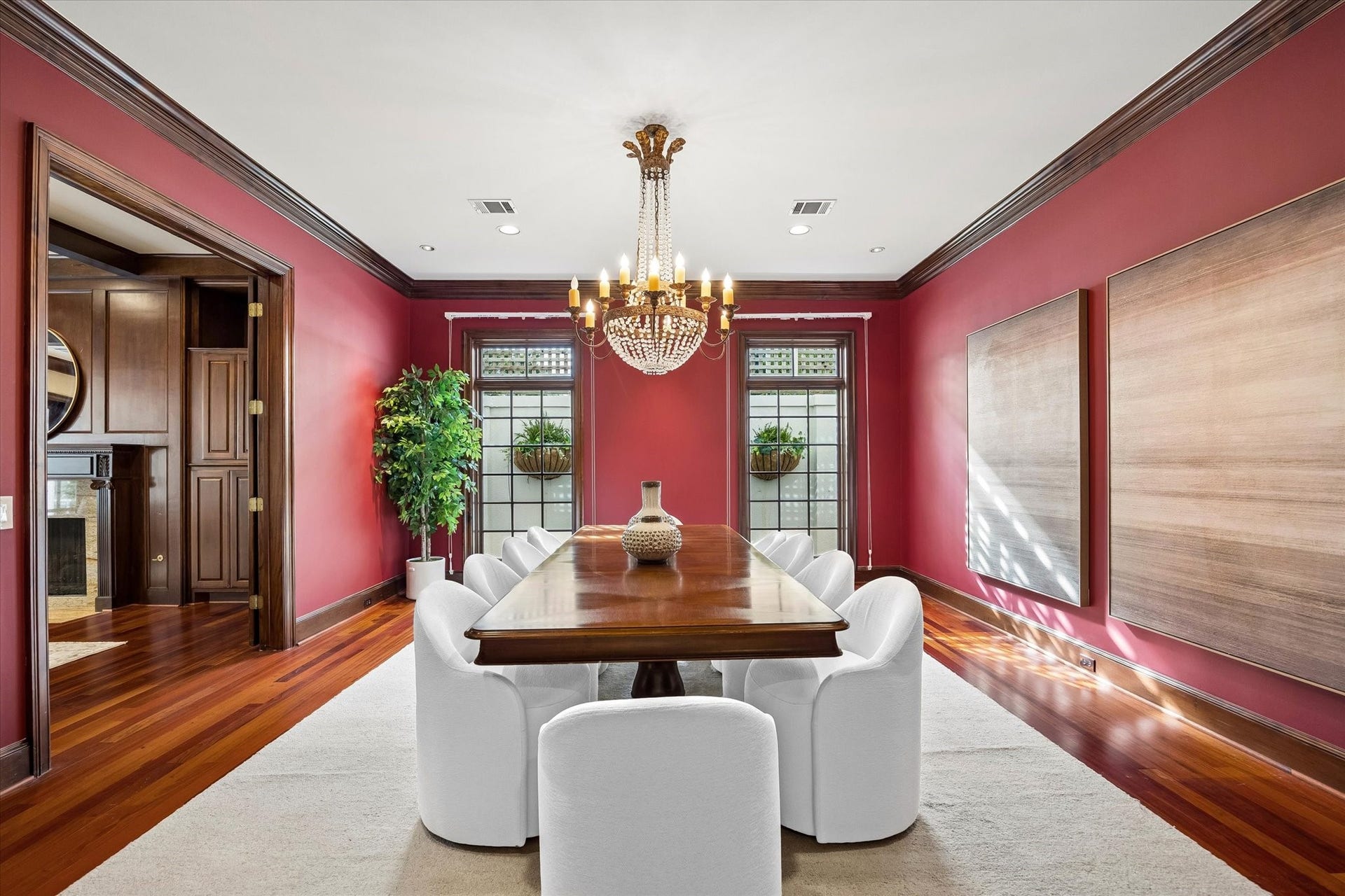 22 Eaton Square, Houston, TX 77027 This striking red formal dining room can accommodate a table for 12, with a stunning iron and crystal chandelier replicated from a chandelier found in an old French convent outside of Rouen.