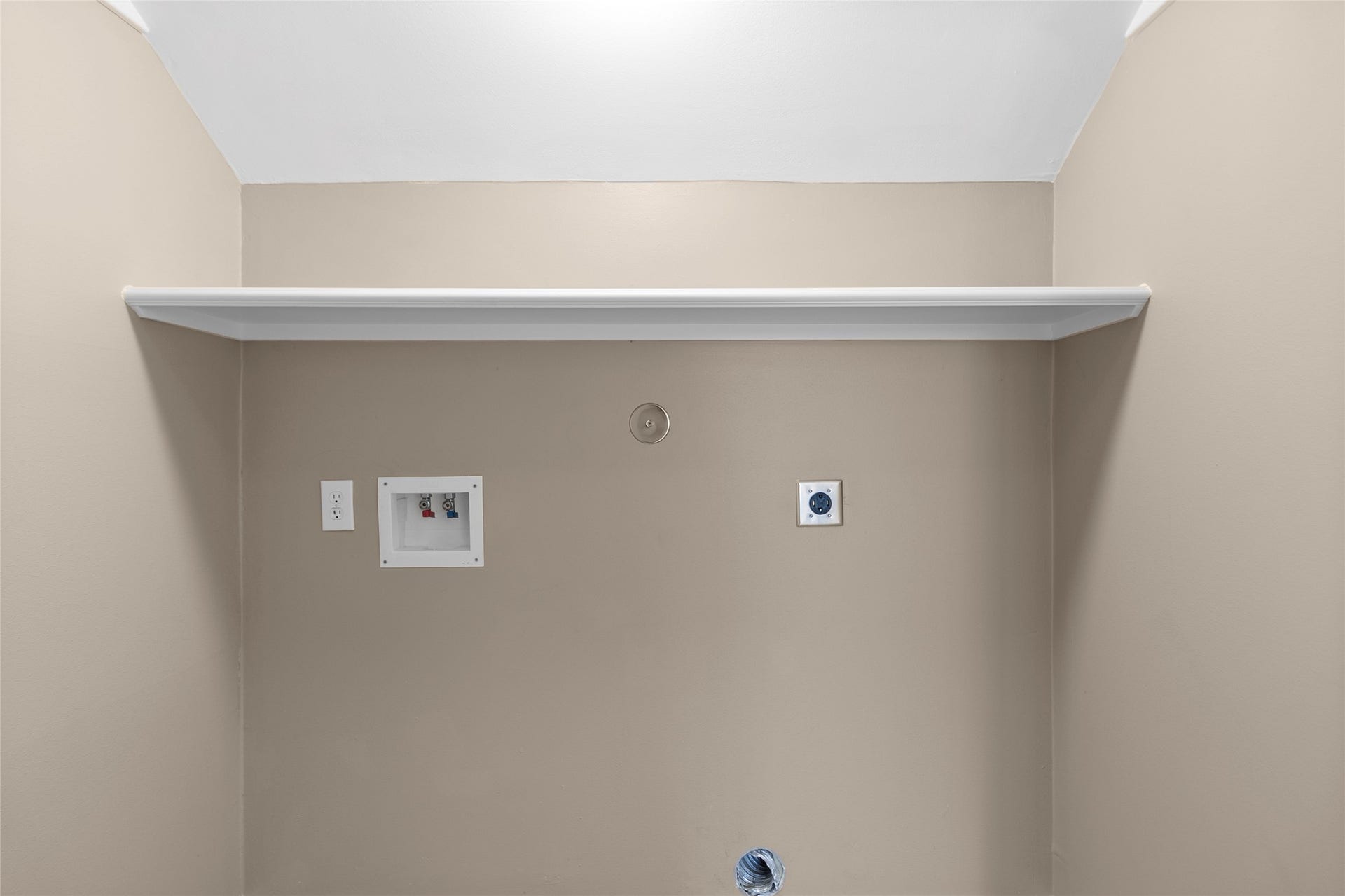 This dedicated laundry area keeps daily routines organized with extra overhead storage space for supplies, linens, and household essentials.