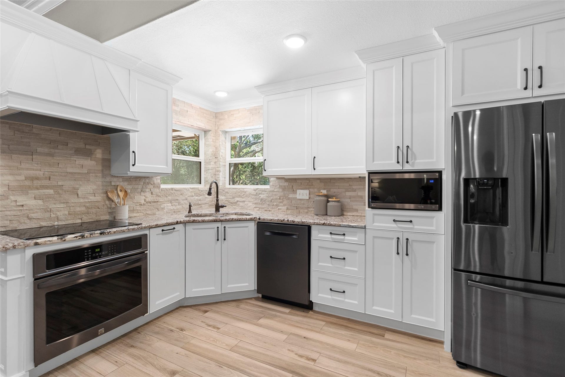 Cooking becomes a pleasure in your beautifully appointed kitchen featuring custom cabinetry, sleek built-in appliances, abundant prep space, and timeless designer finishes throughout.