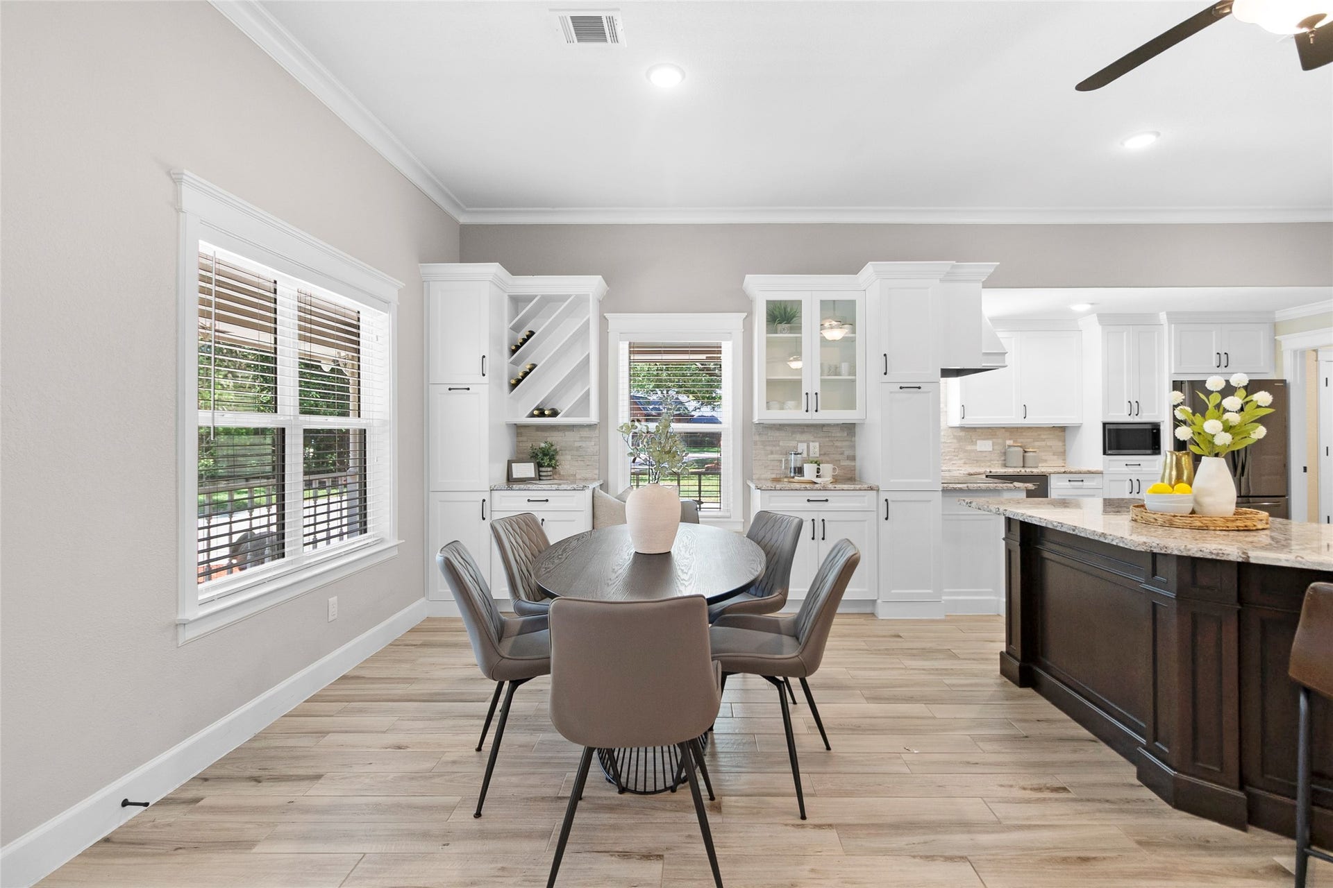 Morning coffee and evening meals feel even more inviting in your light-filled dining area surrounded by oversized windows and seamless access to the heart of the home.